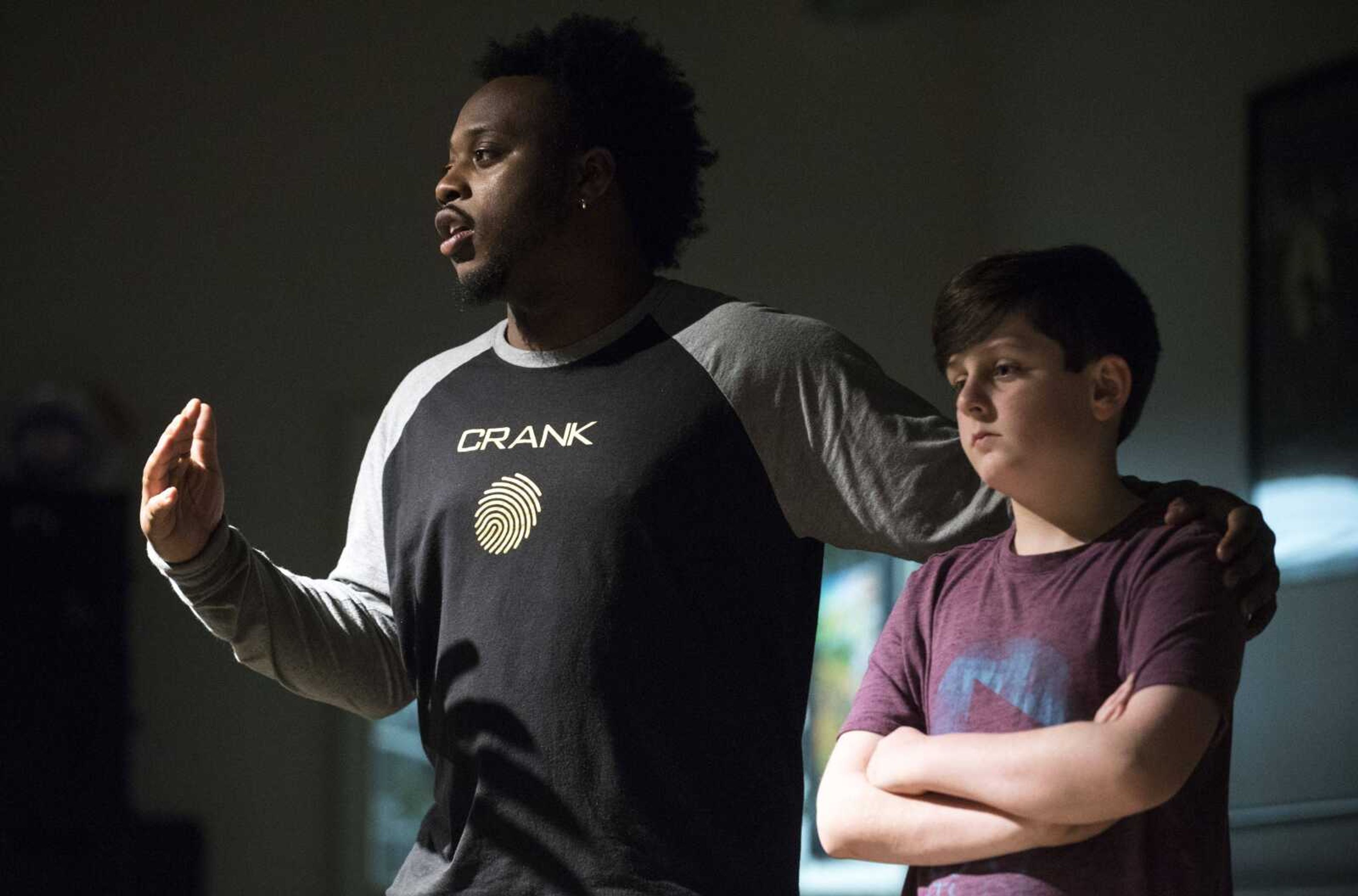 Fingerprint Junior instructor Micheal Curry, left, stands with Everett Motley, 10, while leading a class Feb. 28 at On Cue Performing Arts Studio in Cape Girardeau.