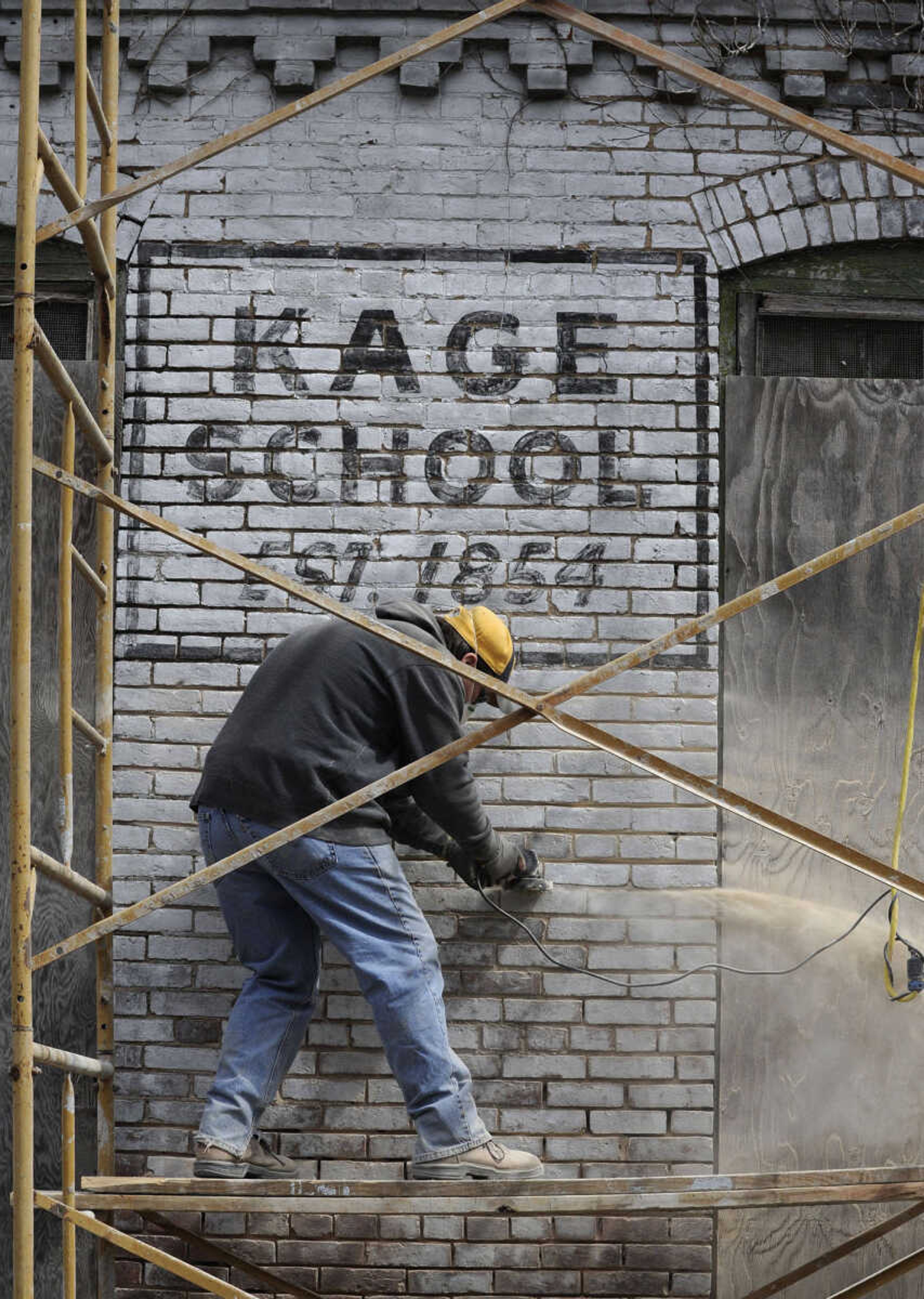 FRED LYNCH ~ flynch@semissourian.com
Justin Wissmann with Langston Masonry & Construction grinds out joints in the brick wall of the old Kage School in preparation for tuckpointing on Monday, March 24, 2014 in Cape Girardeau.