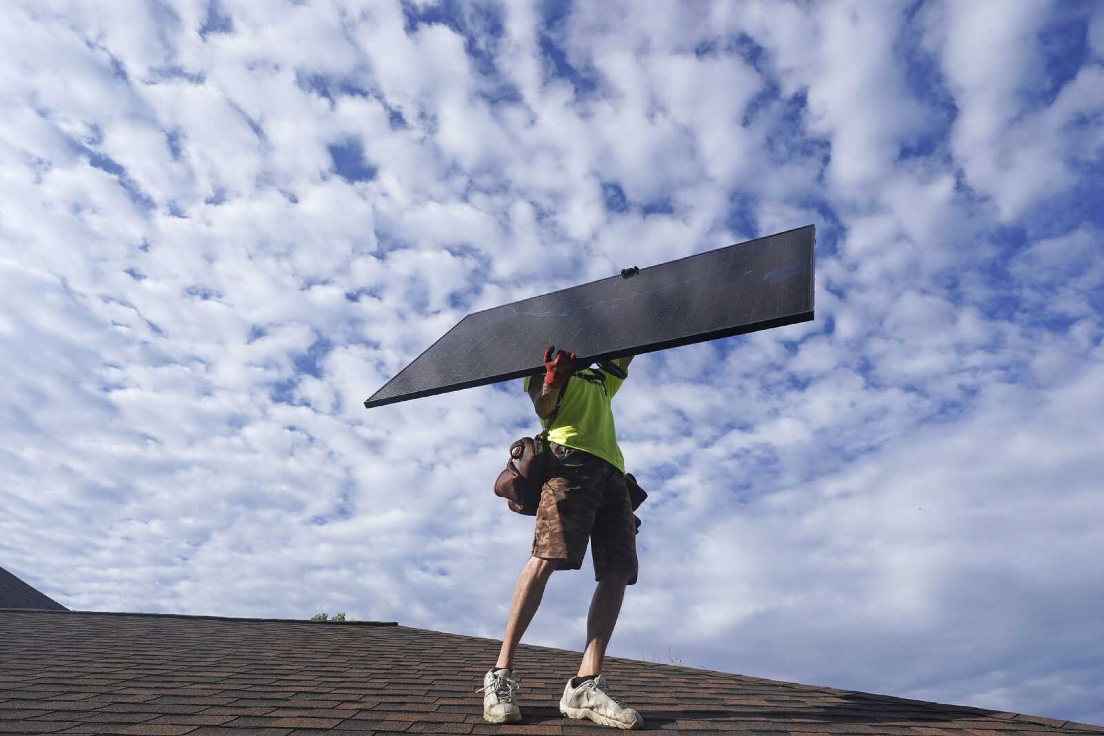 A worker from Power Shift Solar installs a solar panel Thursday in Salt Lake City. Congress is poised to pass a transformative climate change bill today. The crux of the long-delayed bill is to use incentives to accelerate the expansion of clean energy such as wind and solar power, speeding the transition away from the oil, coal and gas that largely cause climate change.