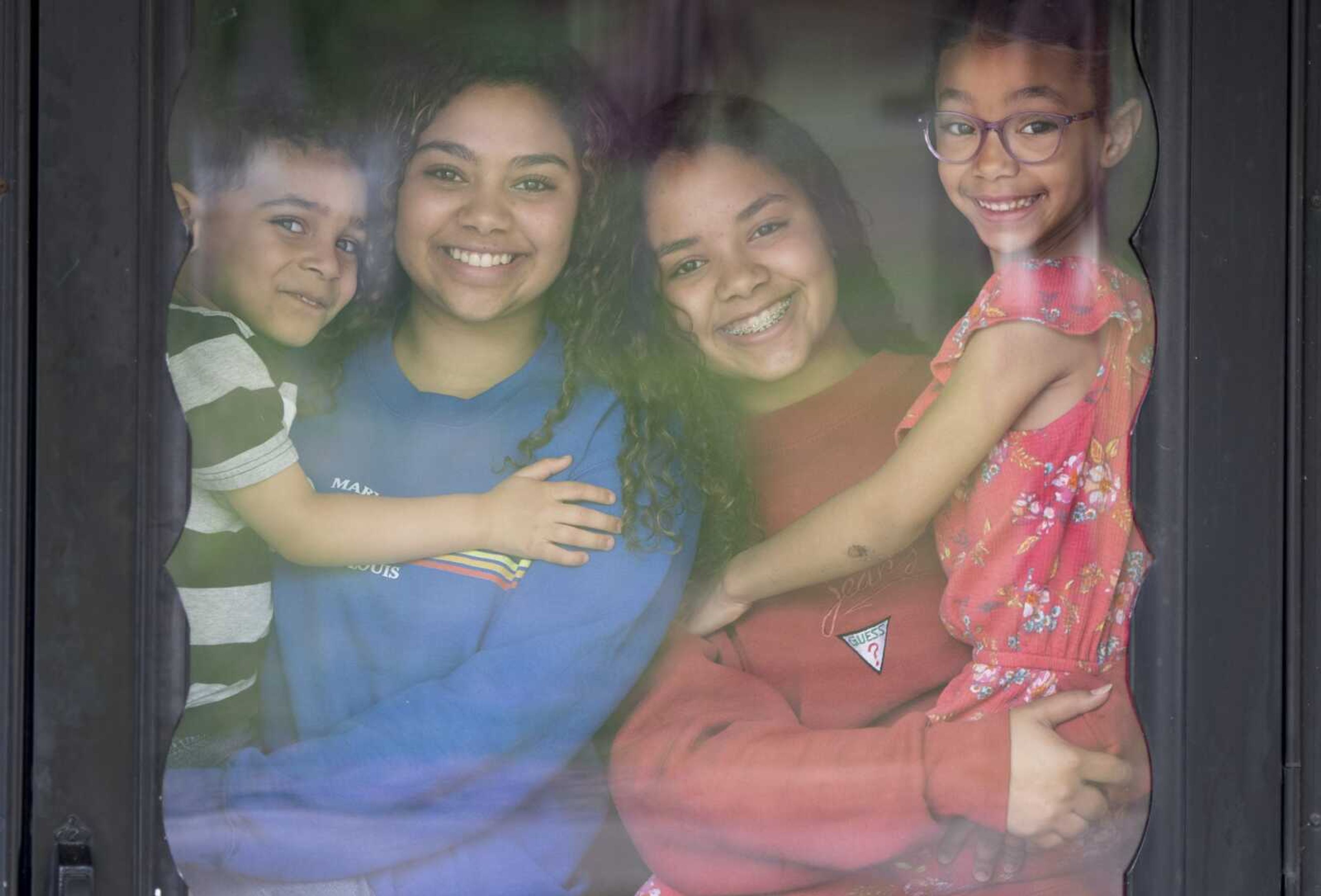 Above left: Siblings, from left, Asher Robinson, 3; Tiana Bowman; Talia Bowman, 15; and Bethani Robinson, 6; pose for a portrait Tuesday at their Cape Girardeau home.