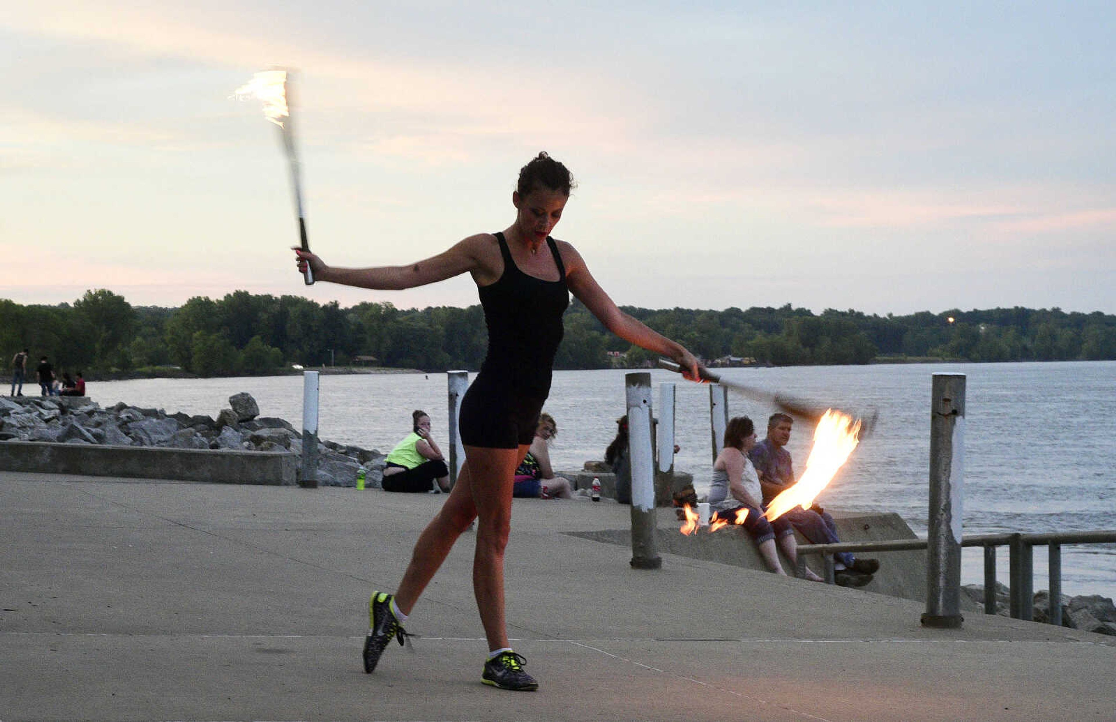 Erin Fluegge twirls flaming knives along the riverfront on Friday, June 16, 2017, in downtown Cape Girardeau.