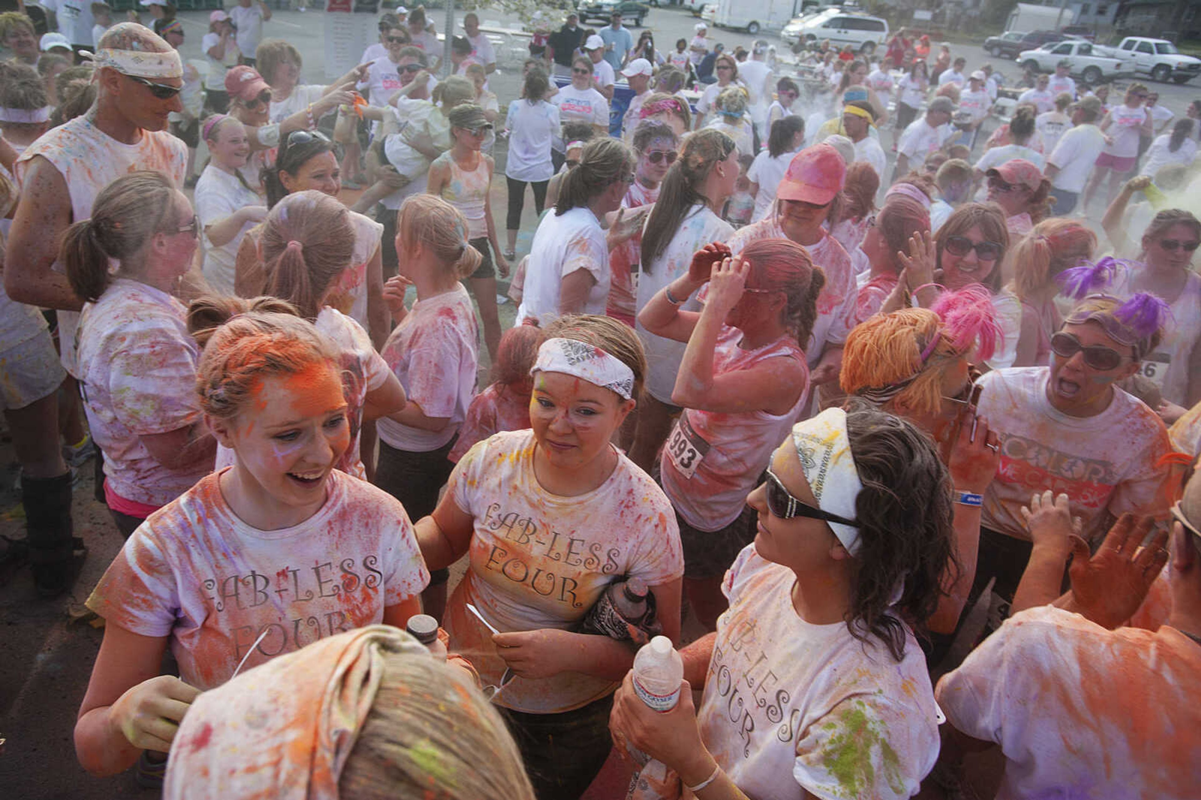 ADAM VOGLER ~ avogler@semissourian.com
Participants in the Color Me Cape 5k street mingle in front of the Bell Air Grill after the color bomb Saturday, April 12, in Cape Girardeau.