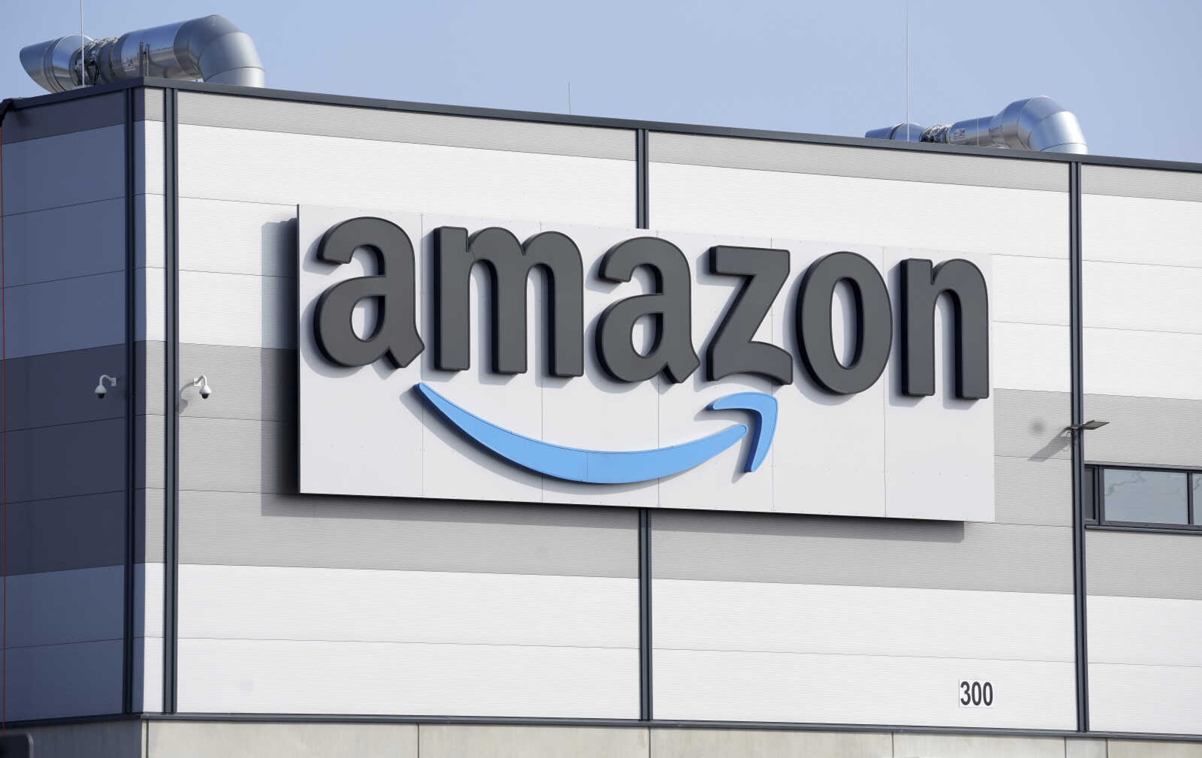 FILE - An Amazon company logo marks the facade of a building in Schoenefeld near Berlin, March 18, 2022. The Federal Trade Commission and 17 state attorney generals filed an antitrust lawsuit against Amazon on Tuesday, Sept. 26, 2023, alleging the e-commerce behemoth uses its position in the marketplace to inflate prices on other platforms, overcharge sellers and stifle competition. (AP Photo/Michael Sohn, File)