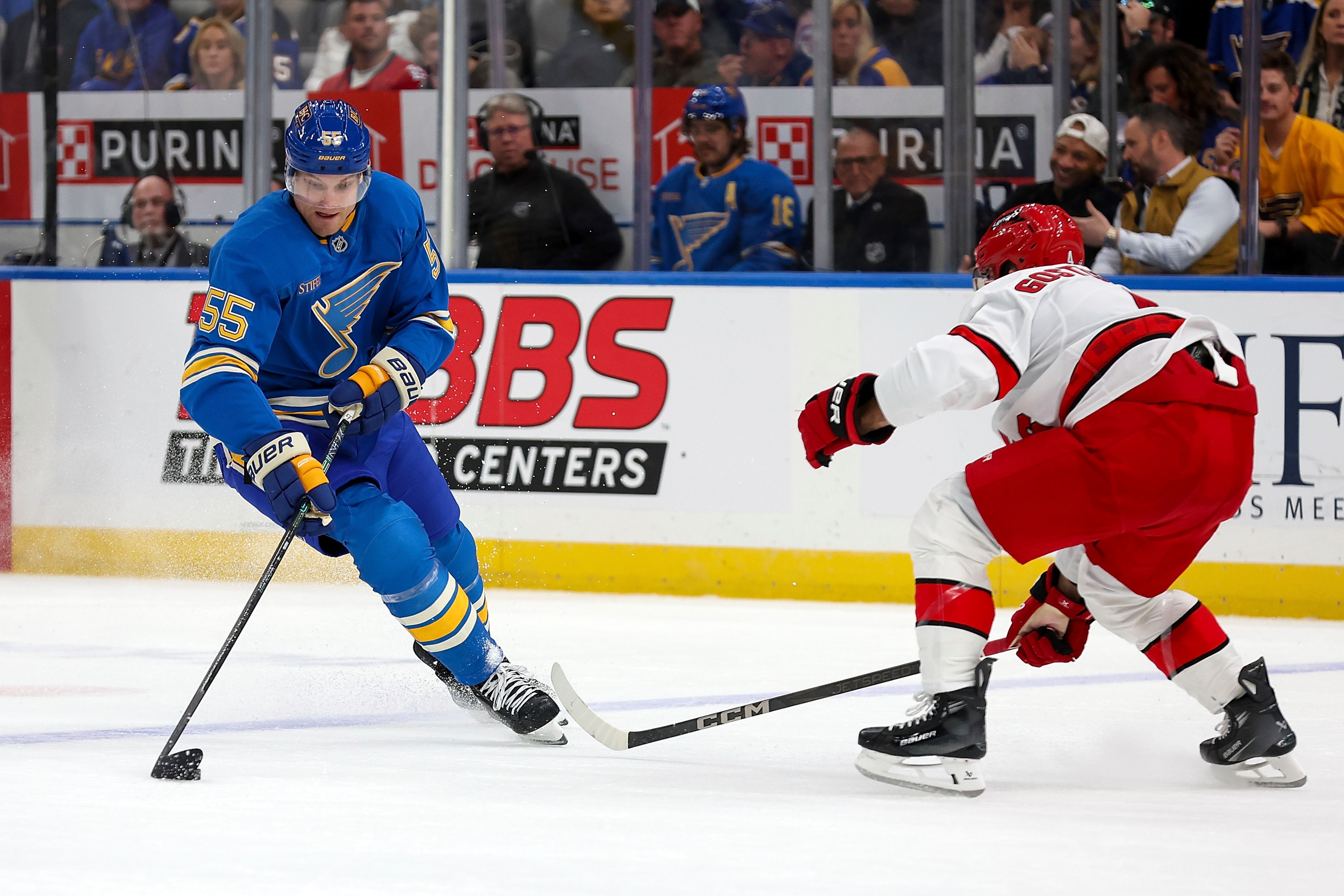 St. Louis Blues' Colton Parayko (55) controls the puck while under pressure from Carolina Hurricanes' Shayne Gostisbehere (4) during the second period of an NHL hockey game Saturday, Oct. 19, 2024, in St. Louis. (AP Photo/Scott Kane)