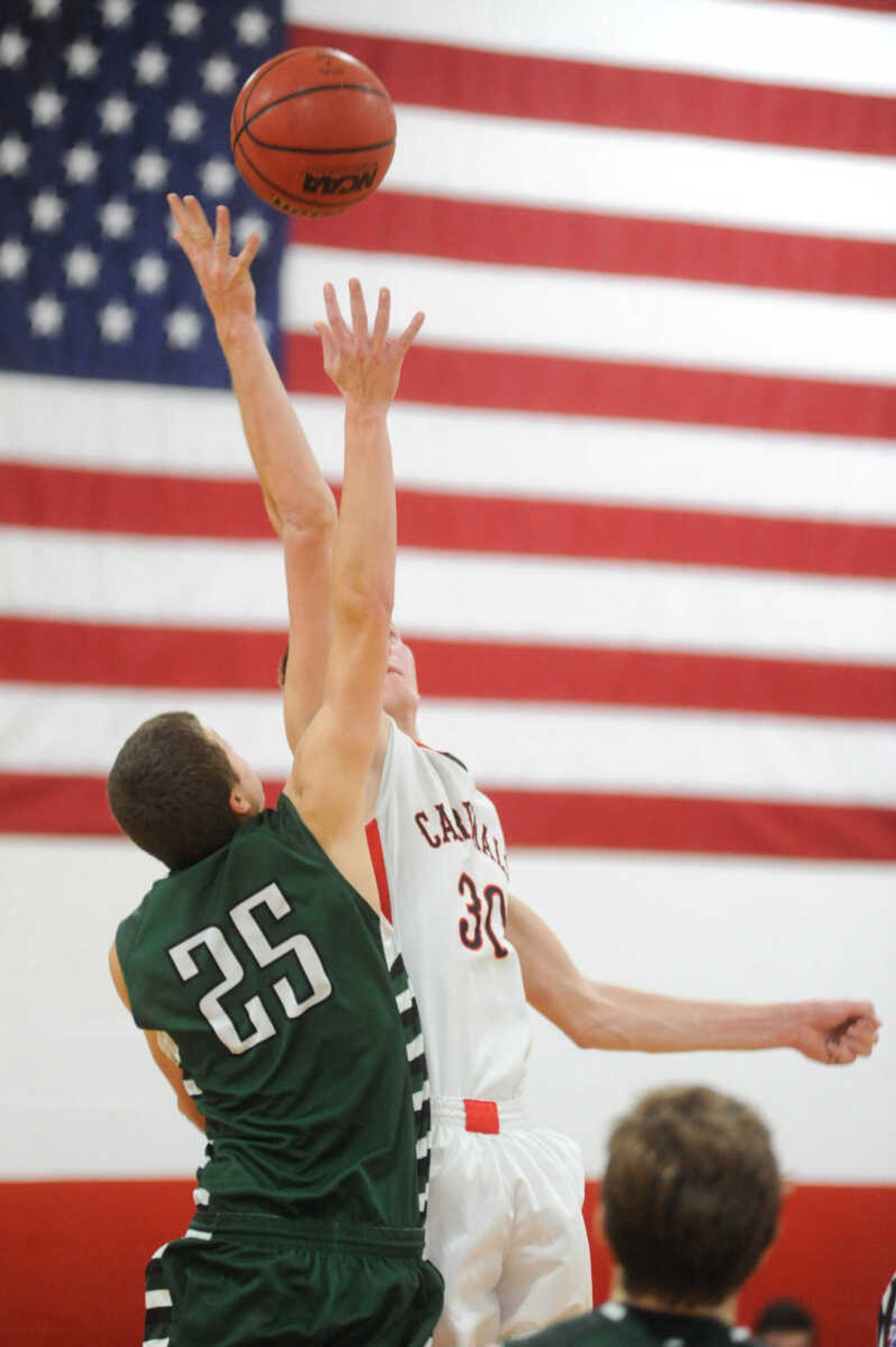 Perryville's Ryan Noland and Woodland's Zach Beel meet for the tip off in overtime during a semifinal game at the Woodland Invitational, Thursday, Dec. 3, 2015, in Marble Hill, Missouri. (Glenn Landberg)