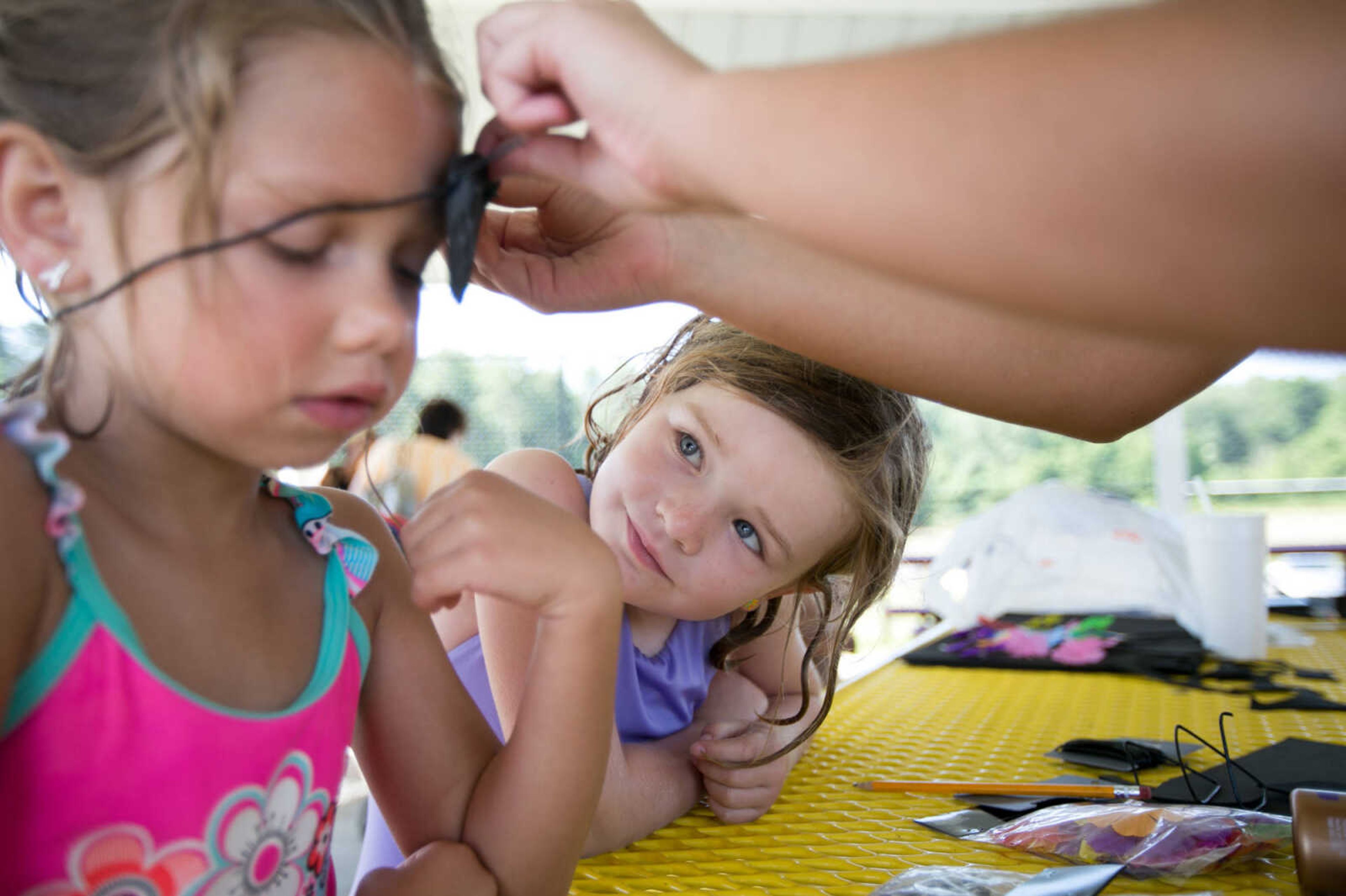 GLENN LANDBERG ~ glandberg@semissourian.com

Halle King watches as Alaina Kintner is fit with an eye patch during the Mermaid and Pirate Party at Cape Splash Saturday, June 18, 2016 in Cape Girardeau.