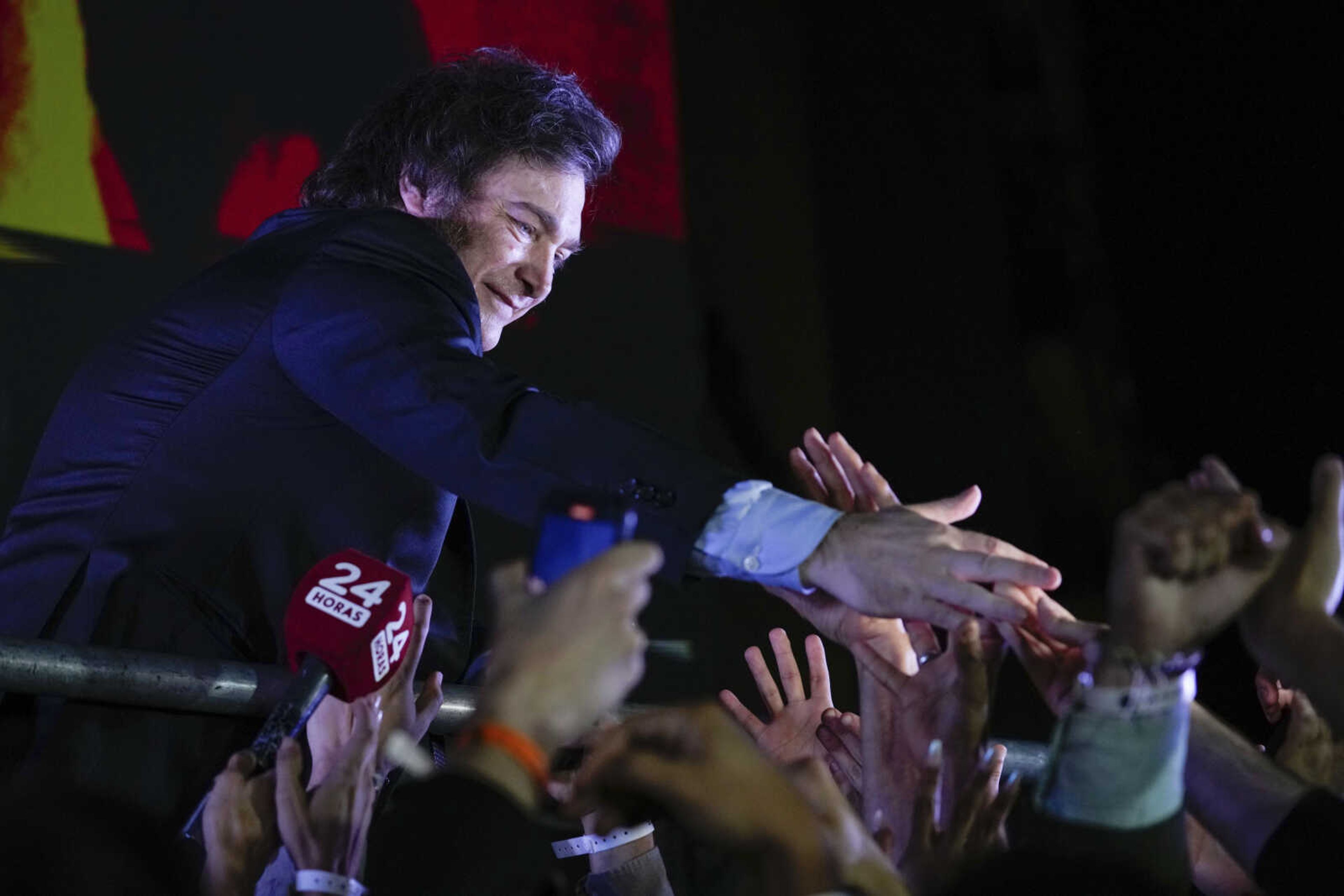 Presidential candidate of the Liberty Advances coalition Javier Milei greets supporters outside his campaign headquarters after winning the presidential runoff election Sunday in Buenos Aires, Argentina.