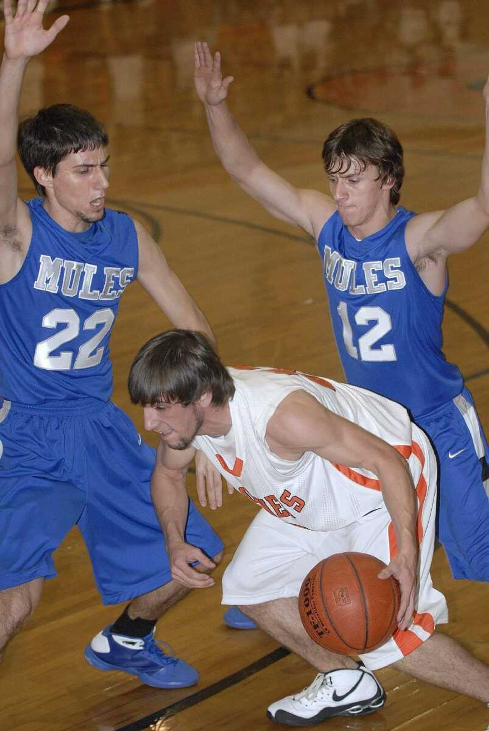 FRED LYNCH ~ flynch@semissourian.comAdvance's Tyler Slinkard is blocked by Bernie's Jake Owens, left, and Jake Welch in the first quarter Friday at Advance.