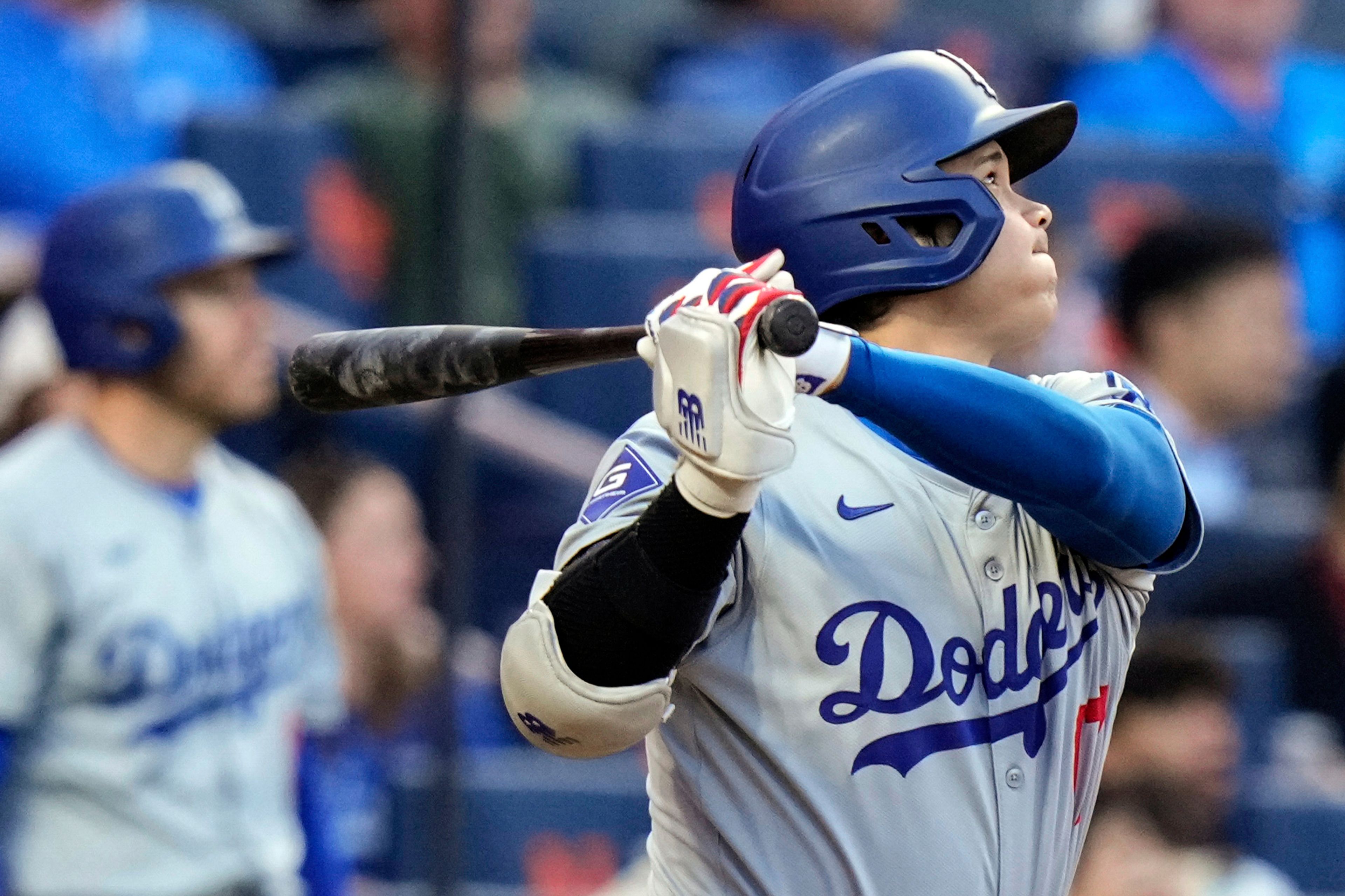 Los Angeles Dodgers' Shohei Ohtani, of Japan, follows through on a two-run home run during the eighth inning of a baseball game against the New York Mets, Wednesday, May 29, 2024, in New York. (AP Photo/Frank Franklin II)