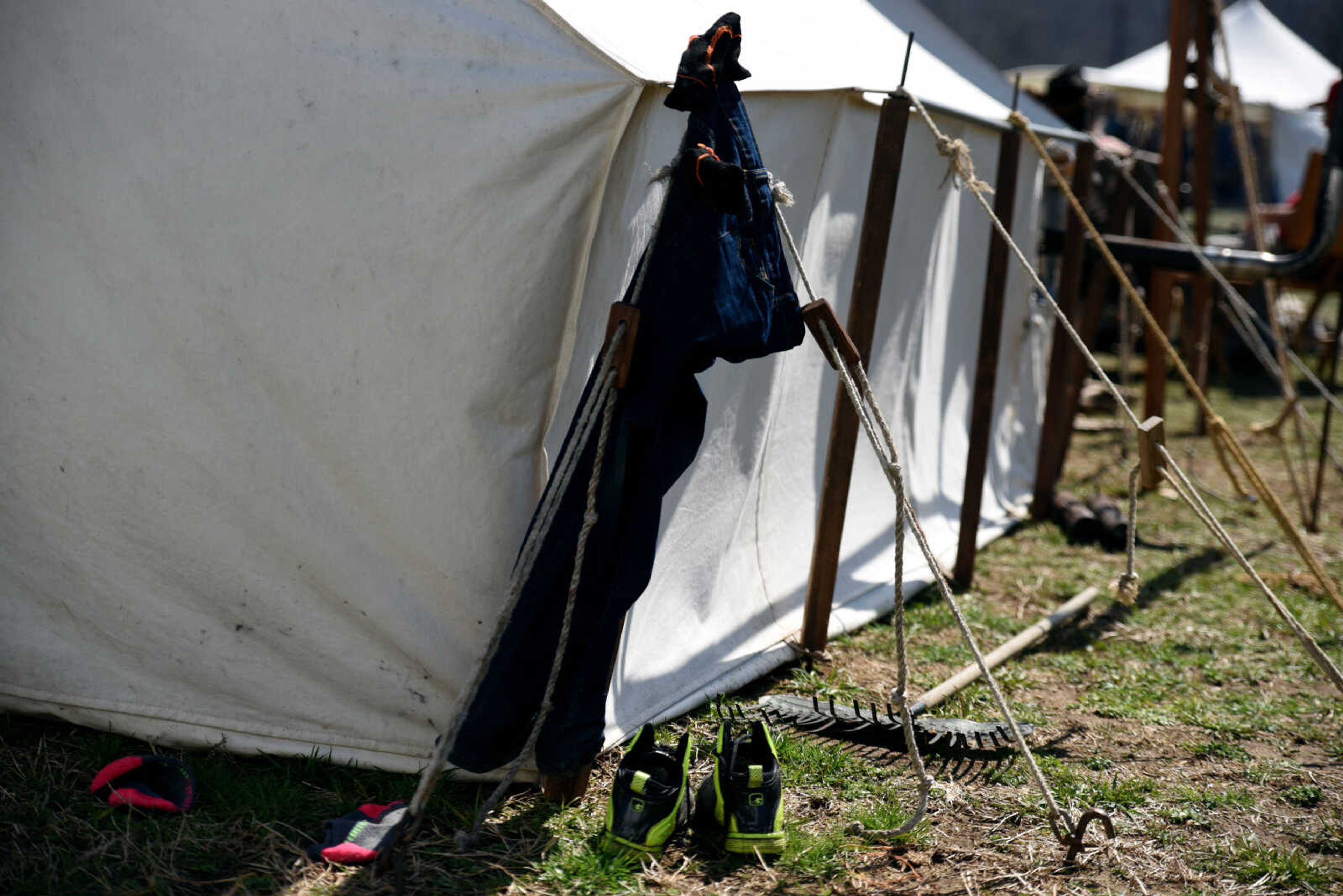 A child's street clothes hang on the side of a tent at the second annual Eastern Ozark Rendezvous held at Bark's Planation Saturday, March 17, 2018, in Glenallen.