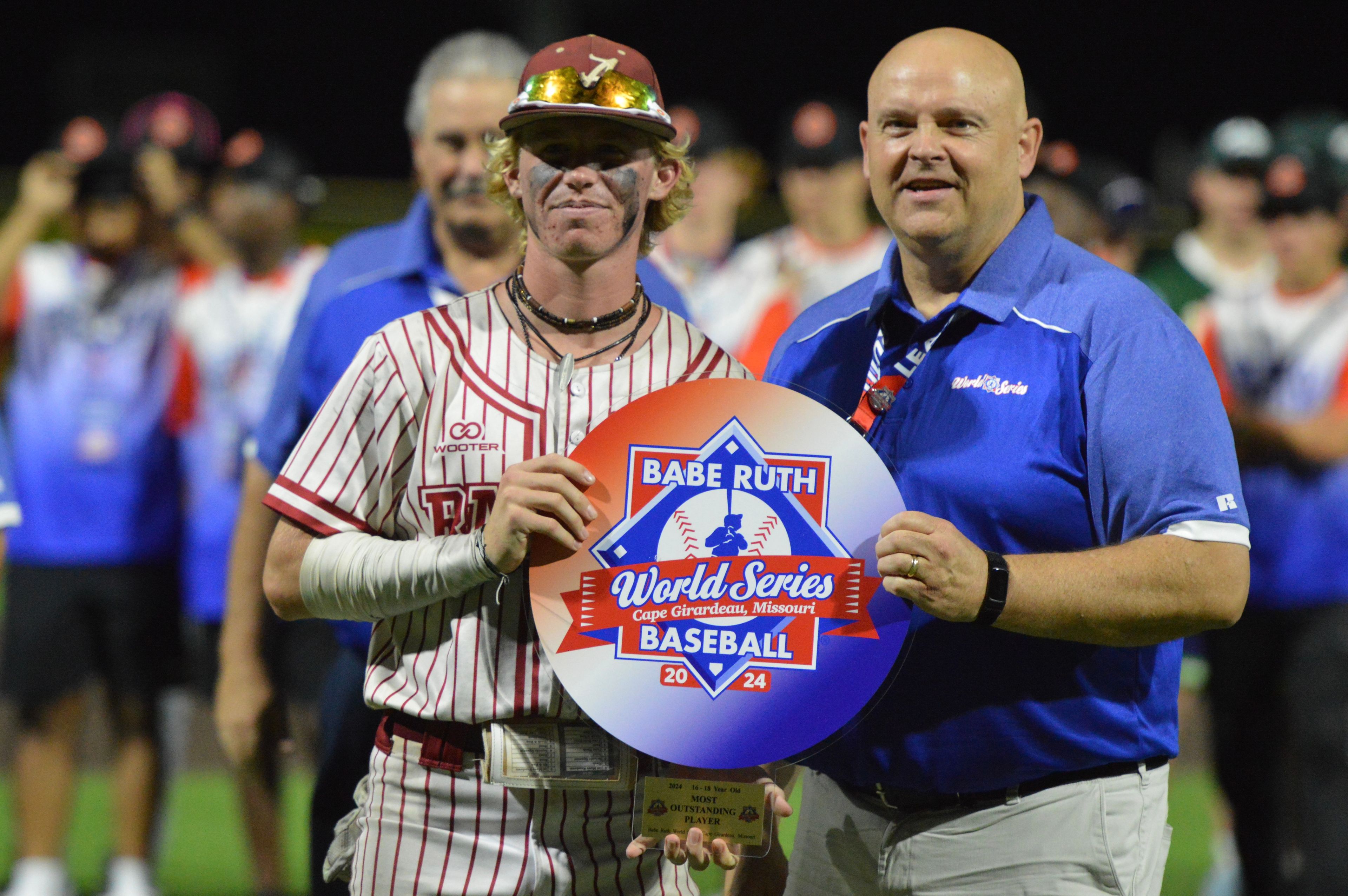 Alabama Rawdogs’ Joseph Stevens is handed the Most Outstanding Player trophy at the Babe Ruth World Series on Thursday, Aug. 15, at Capaha Field in Cape Girardeau, Mo. 