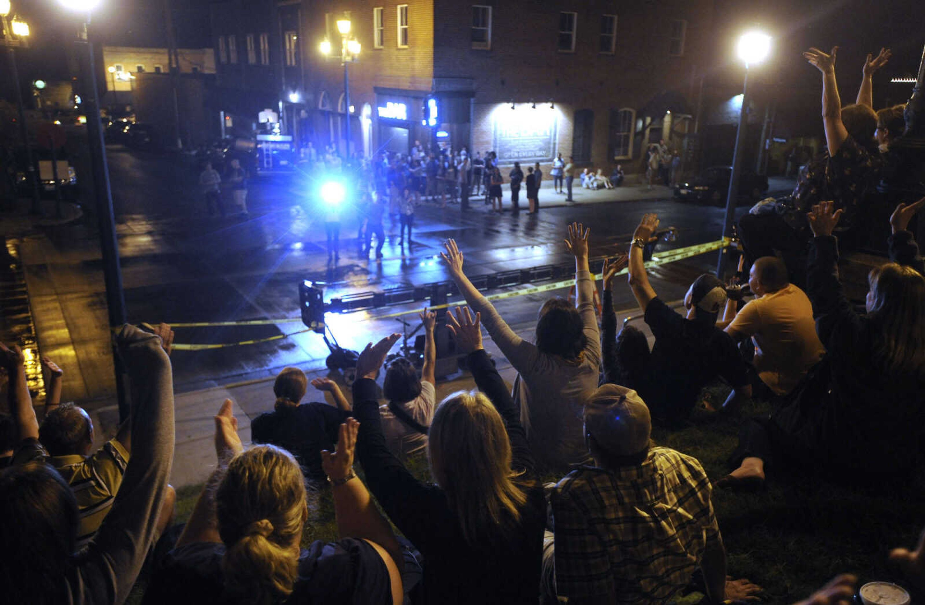 FRED LYNCH ~ flynch@semissourian.com
A "Gone Girl" crew member snaps a picture of the spectators before filming began Friday, Sept. 27, 2013 in downtown Cape Girardeau.