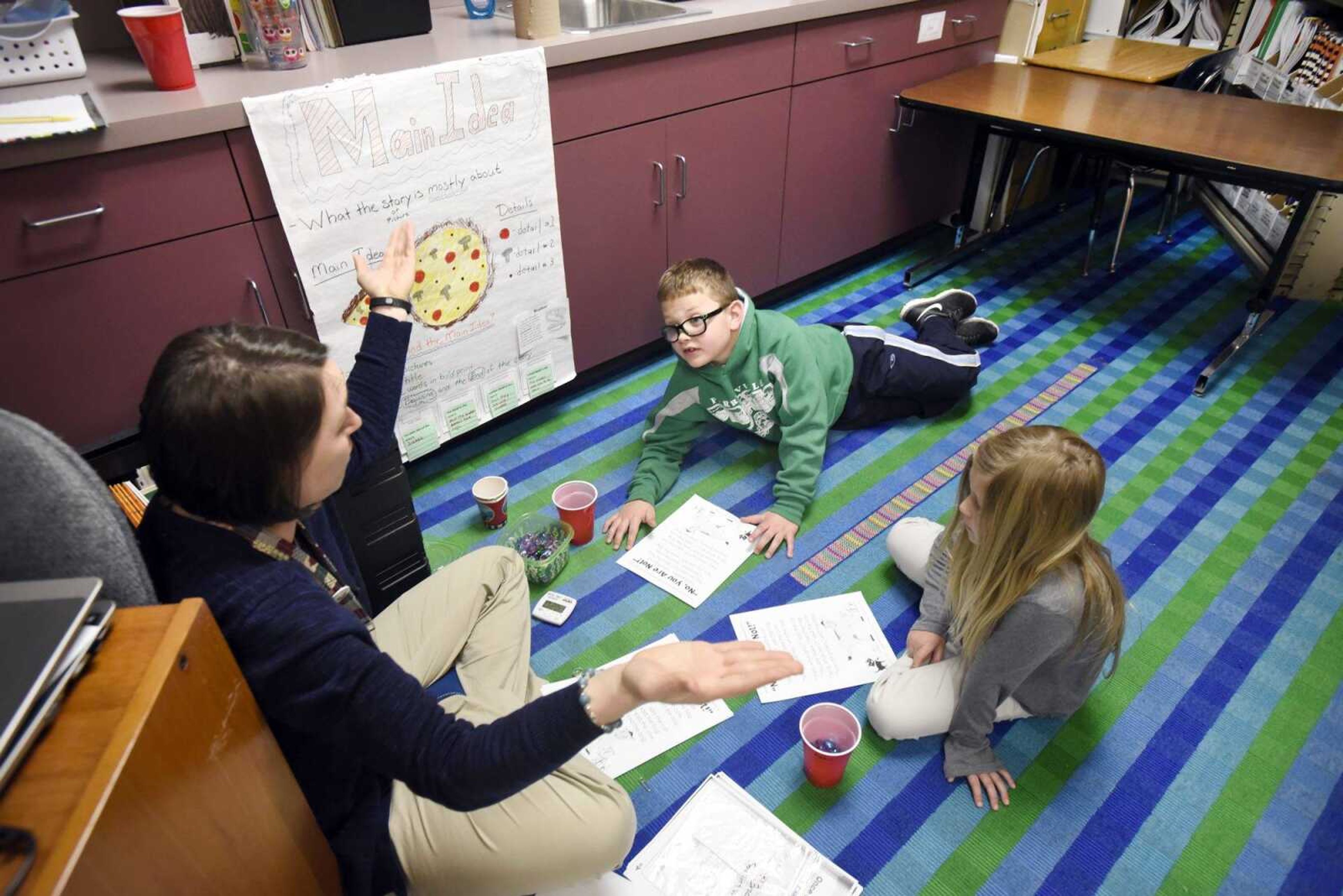 Reading teacher Megan Roth works with Alex Ponder and Zoey Buchheit in a corner of her classroom Wednesday at Perryville Elementary.