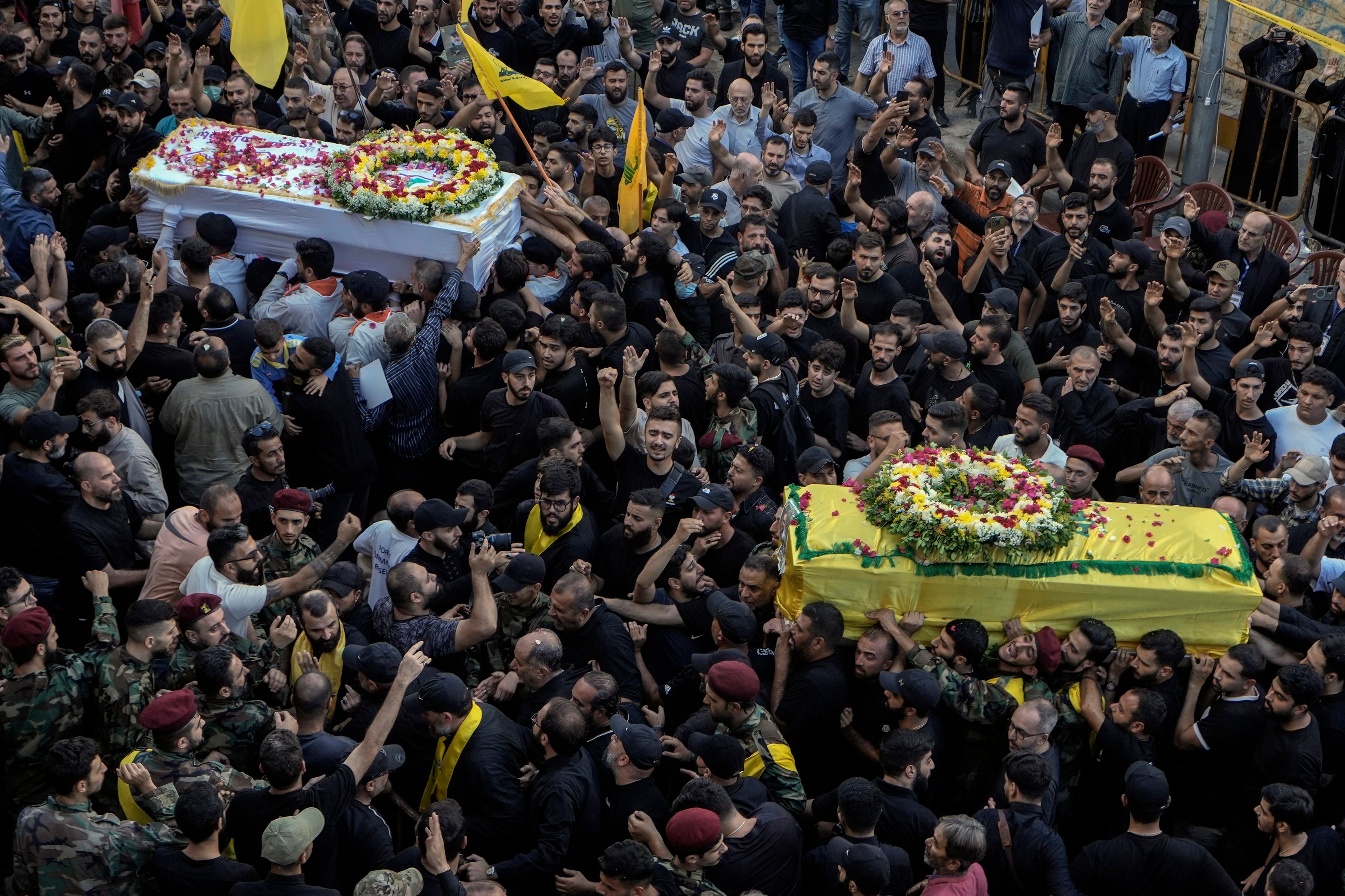 Mourners carry the coffins of victims who were killed Tuesday after their handheld pagers exploded, during their funeral procession in the southern suburb of Beirut, Lebanon, Wednesday, Sept. 18, 2024. (AP Photo/Bilal Hussein)