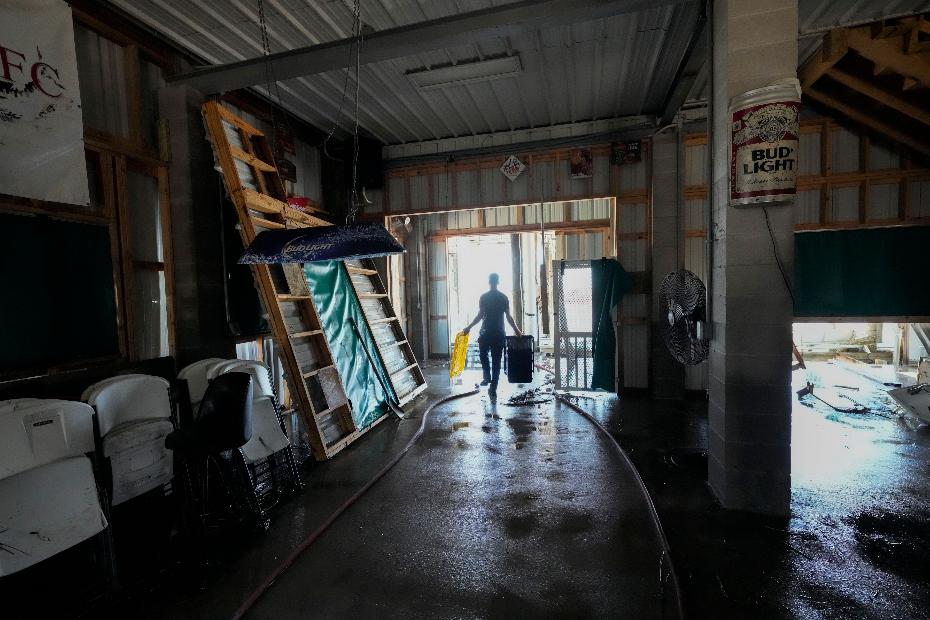 Allen McCoy helps clean out his family's camp, which took on a storm surge, in the aftermath of Hurricane Francine, in Cocodrie, La., Thursday, Sept. 12, 2024. (AP Photo/Gerald Herbert)