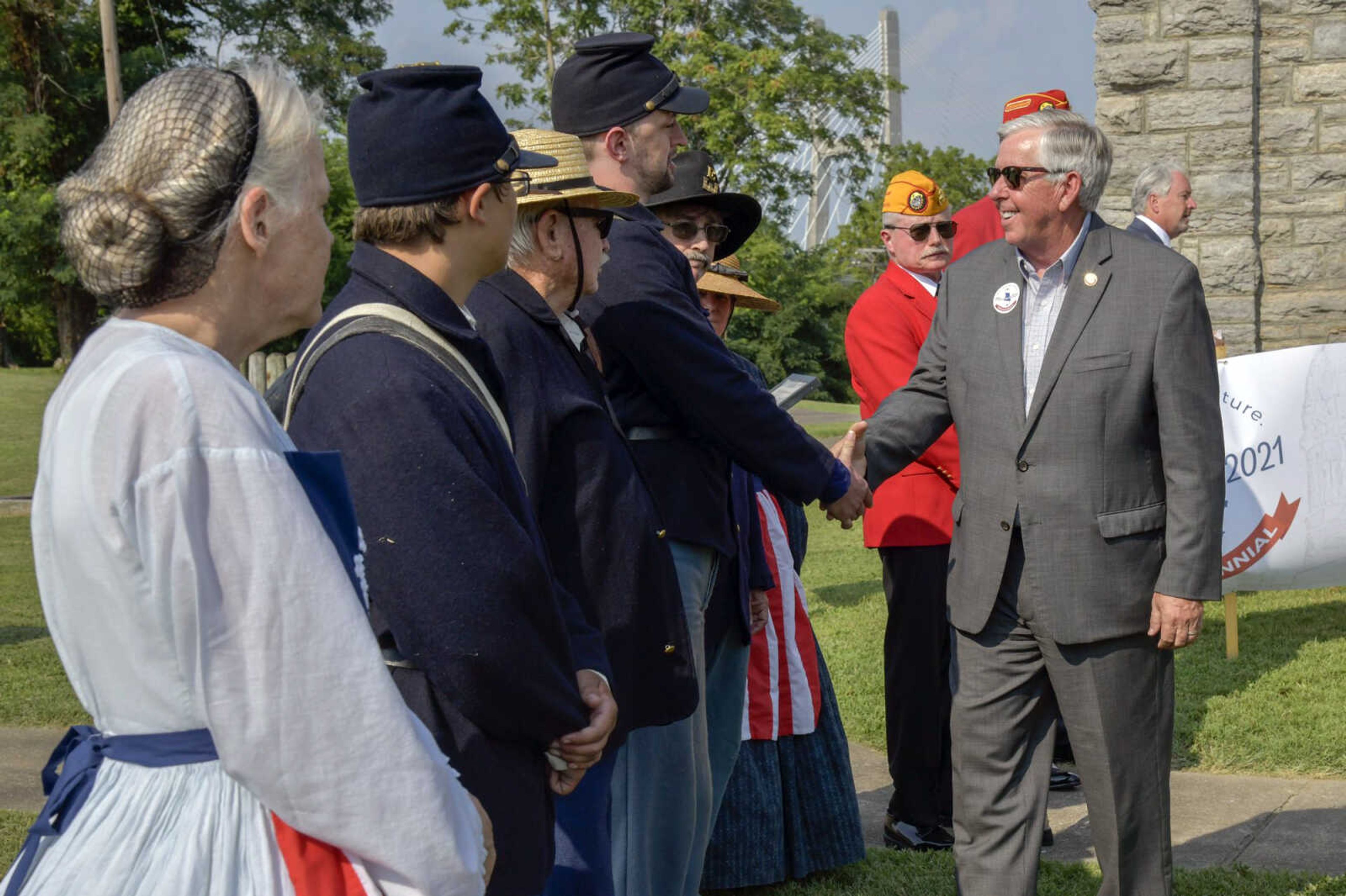 Gov. Mike Parson shakes hands with those who work at Fort D Historic Site on Monday in Cape Girardeau as part of his state Bicentennial Tour.