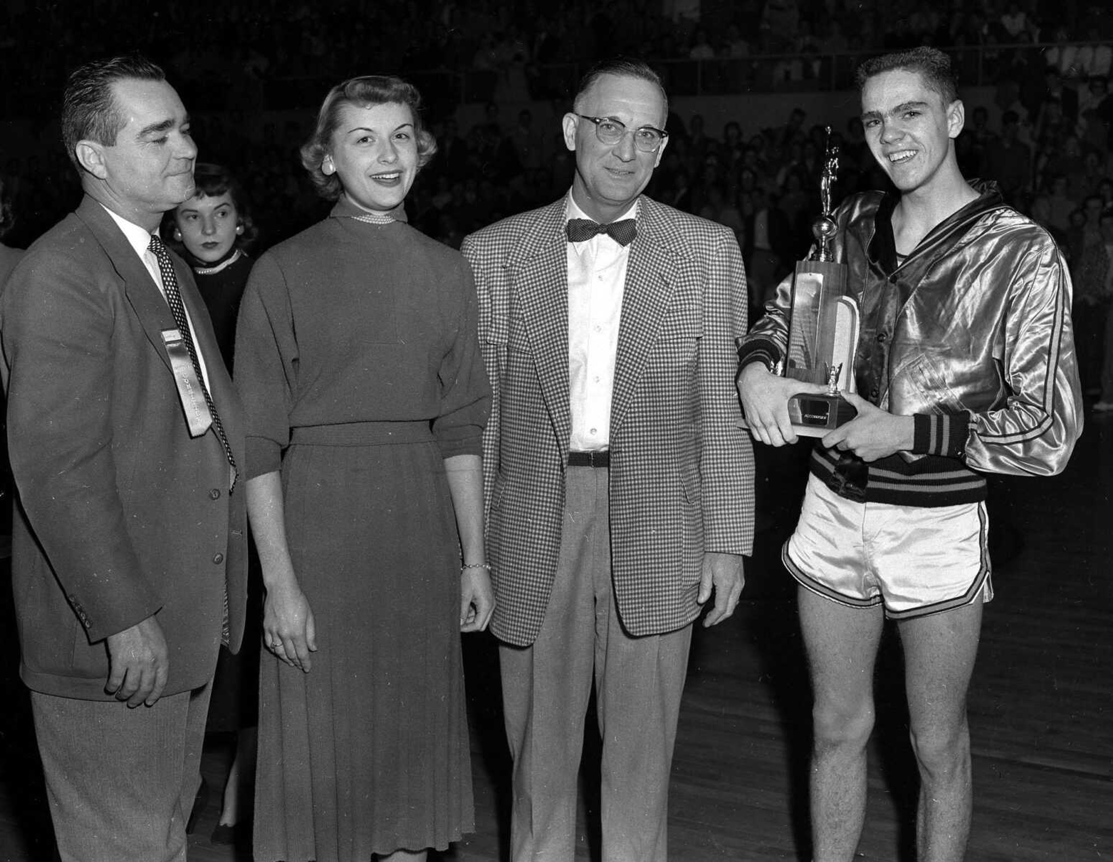 Shown at right is Paul Stehr of Cape Girardeau. Central High won MVP honors following the state basketball tournament in 1954. The Central Tigers were tournament champions. At left are Maurice Dunklin and  Glenda Jones, who had charge of presentation. Fourth person is James F. Miller, tourney committee chairman.