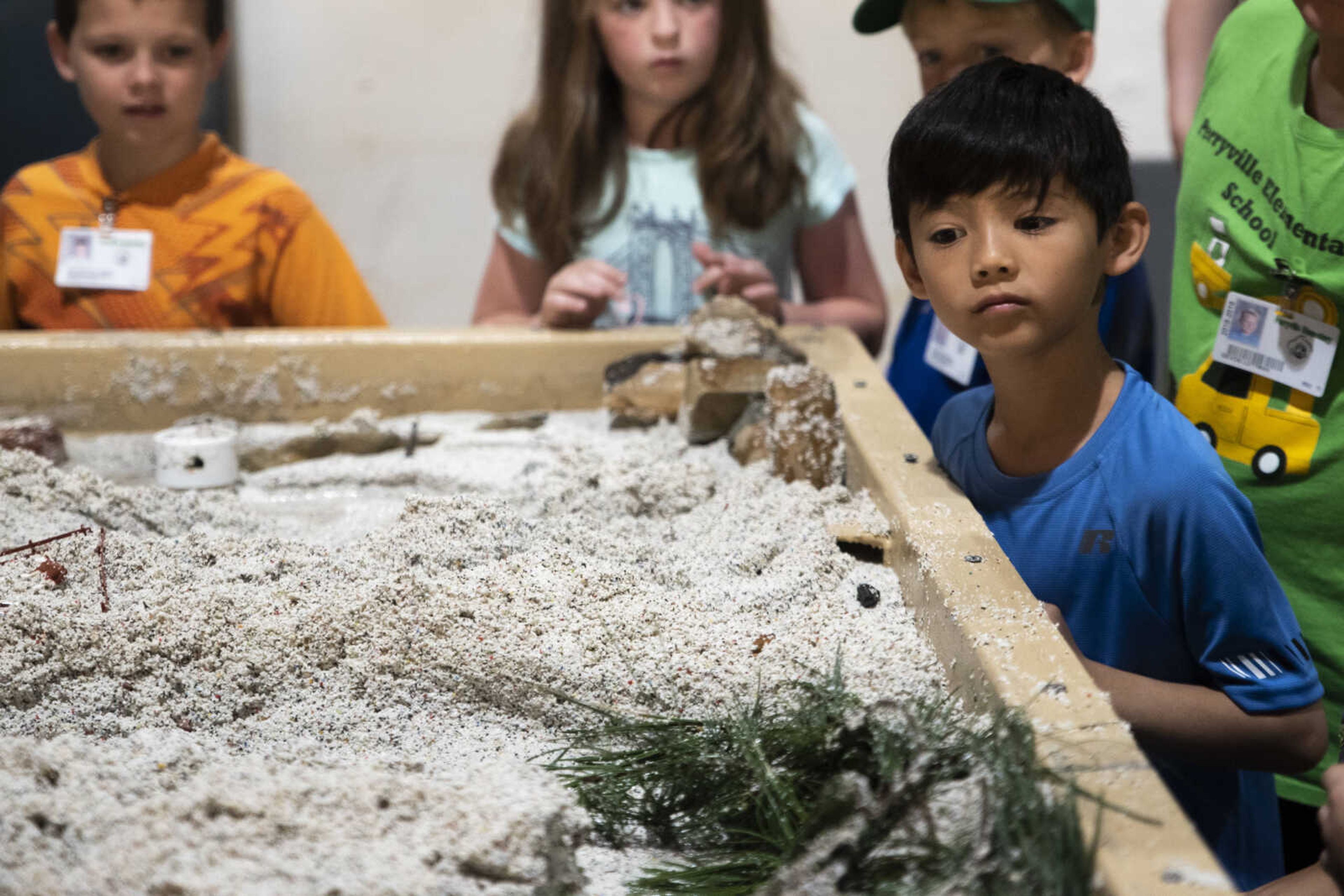 Students from Perryville watch a stream table demonstration during the 24th annual Farm Day sponsored by the Southeast Missouri Cattlemen's Association at Flickerwood Arena Wednesday, April 24, 2019, in Jackson. Over 800 students attended Farm Day and learned about a variety of farm-related topics from forestry to soil conservation, as well as farm animals and honey bees.