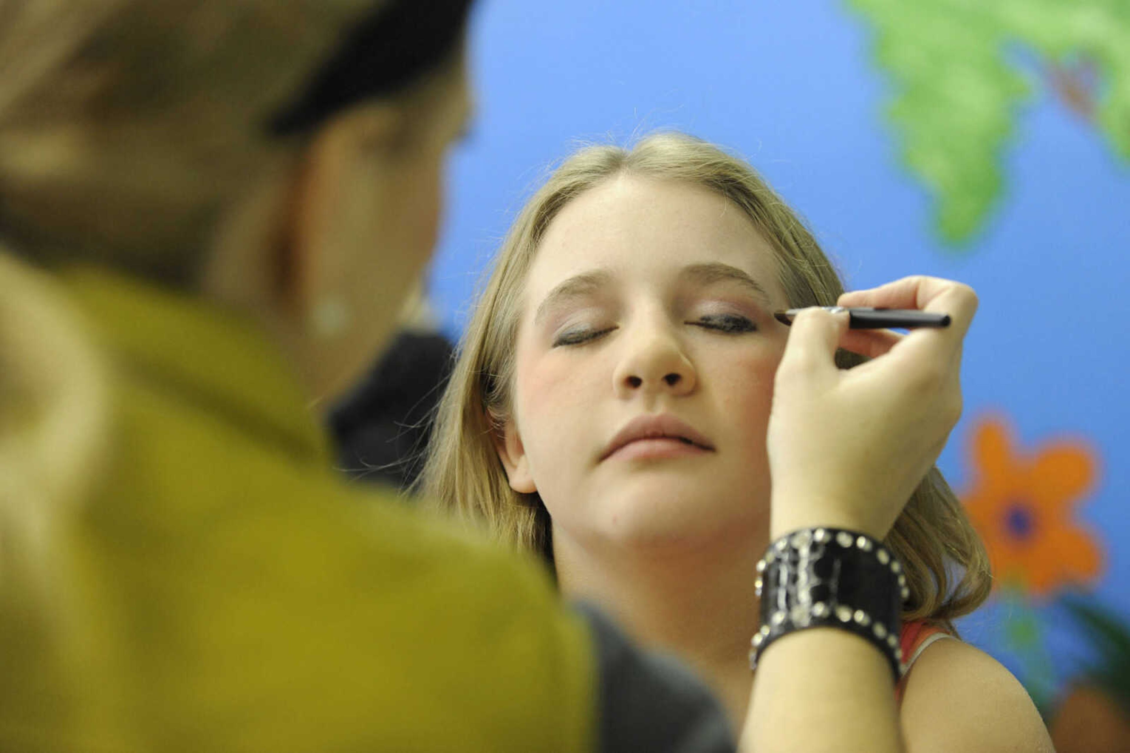 GLENN LANDBERG ~ glandberg@semissourian.com

Maddie Johnston has her make-up done by Jenn Crass before her photo session during the fifth annual Help-Portrait event Saturday, Dec. 6, 2014 at the House of Hope in Cape Girardeau.