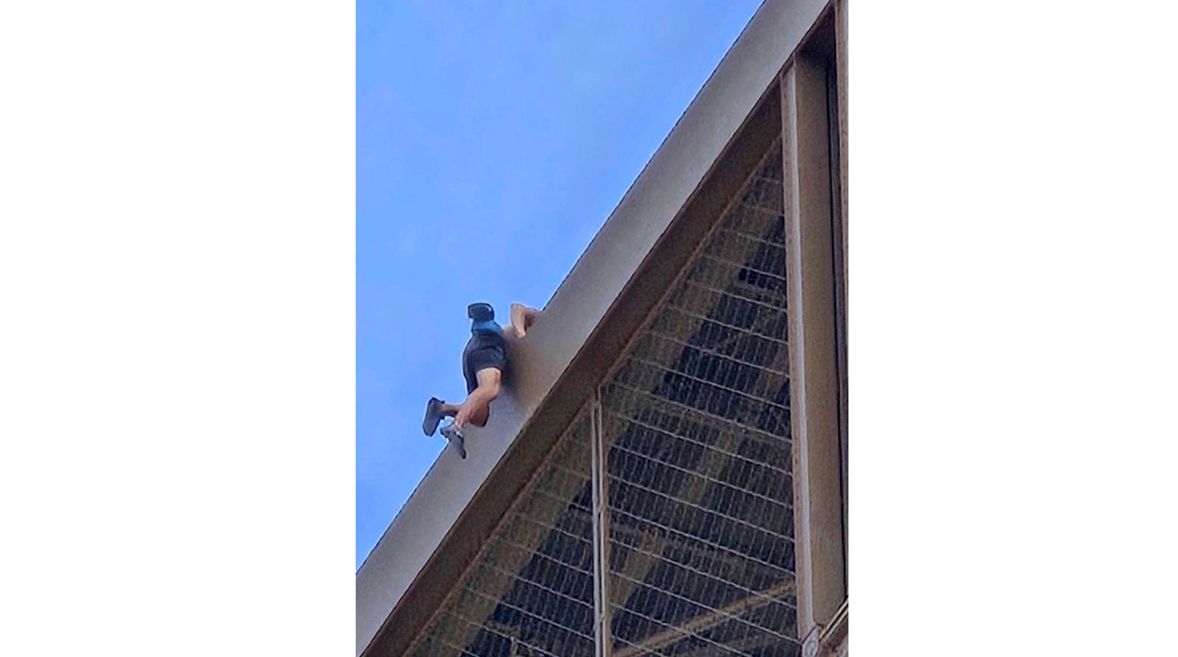 In this photo provided by Nickey Worlock, a man climbs the Eiffel Tower, during the 2024 Summer Olympics, Sunday, Aug. 11, 2024, in Paris France. (Nickey Worlock via AP)