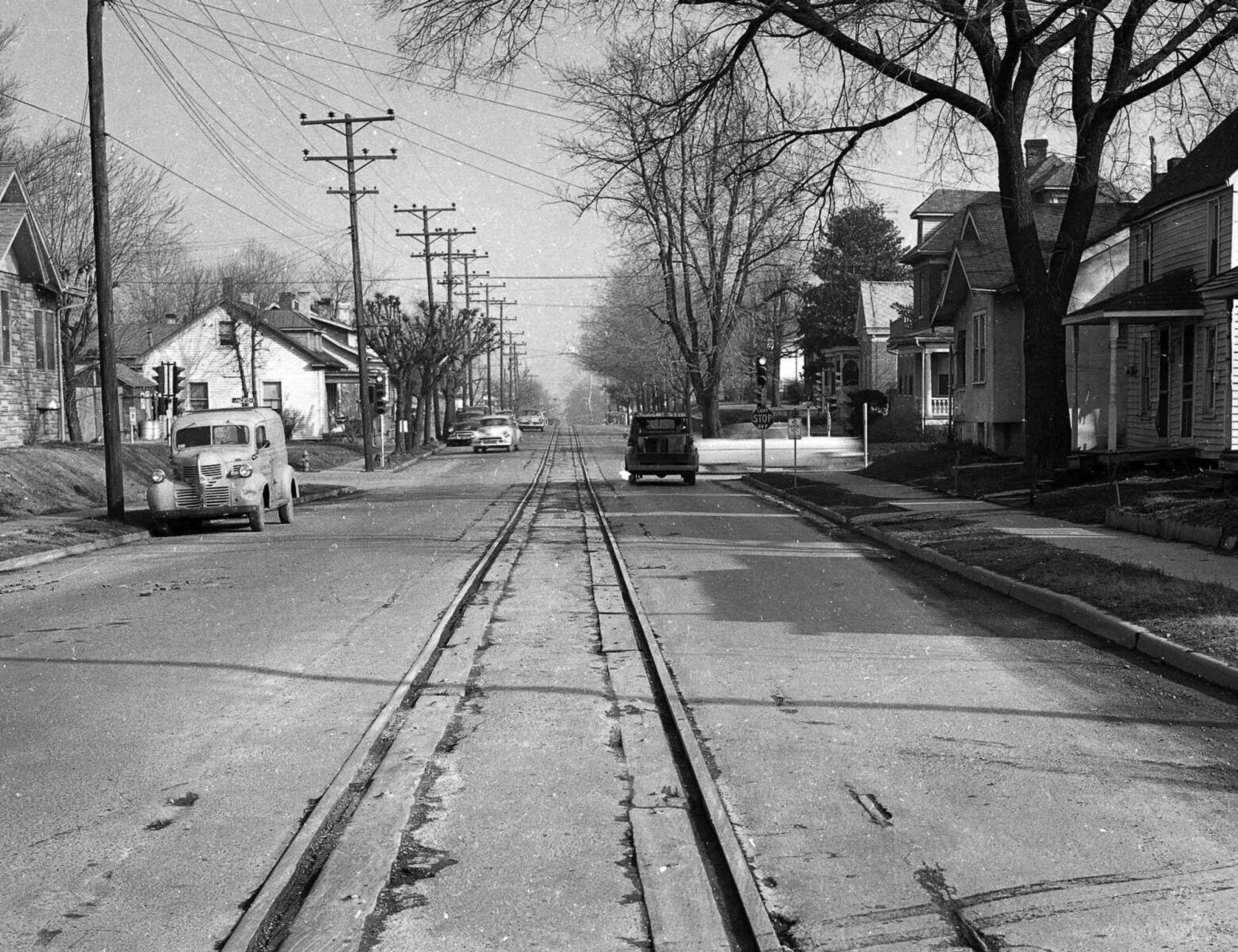 Train tracks split Independence Street for many years. This photograph was taken just west of Pacific Street, looking east.