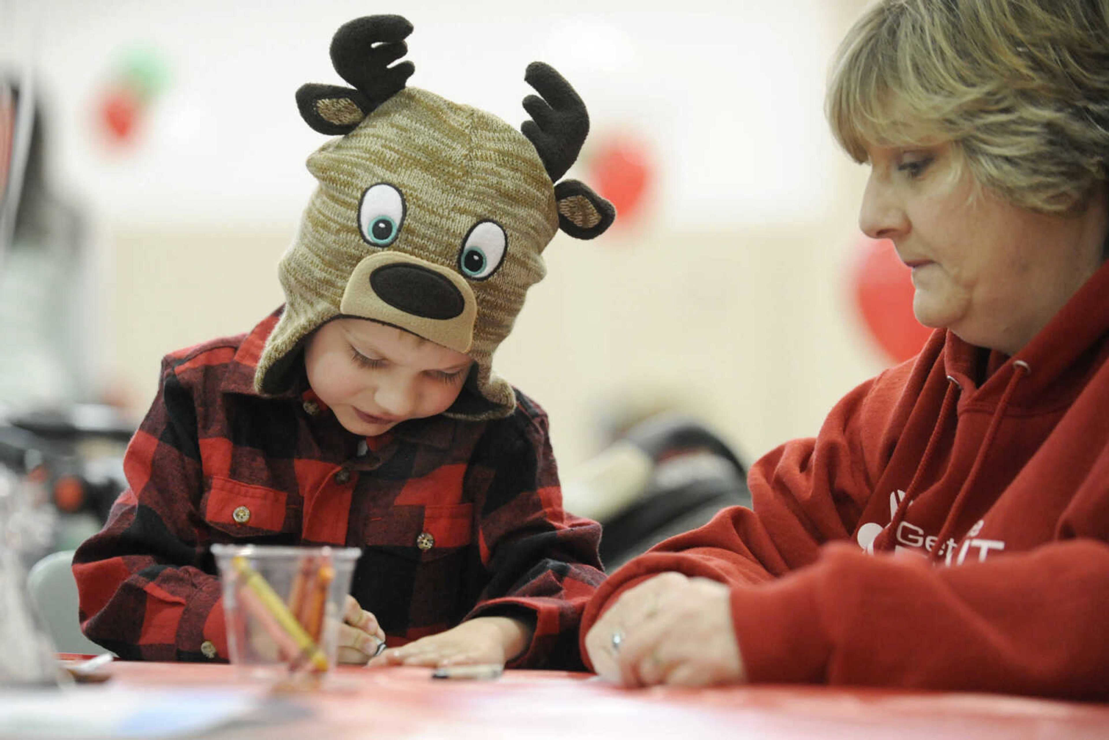 GLENN LANDBERG ~ glandberg@semissourian.com

Brogan Carty works on a drawing with his grandmother, Karen Davis before visiting with Santa during a fund raiser for the Cape Girardeau Parks and Recreation Foundation Saturday, Dec. 13, 2014 at the Osage Centre.