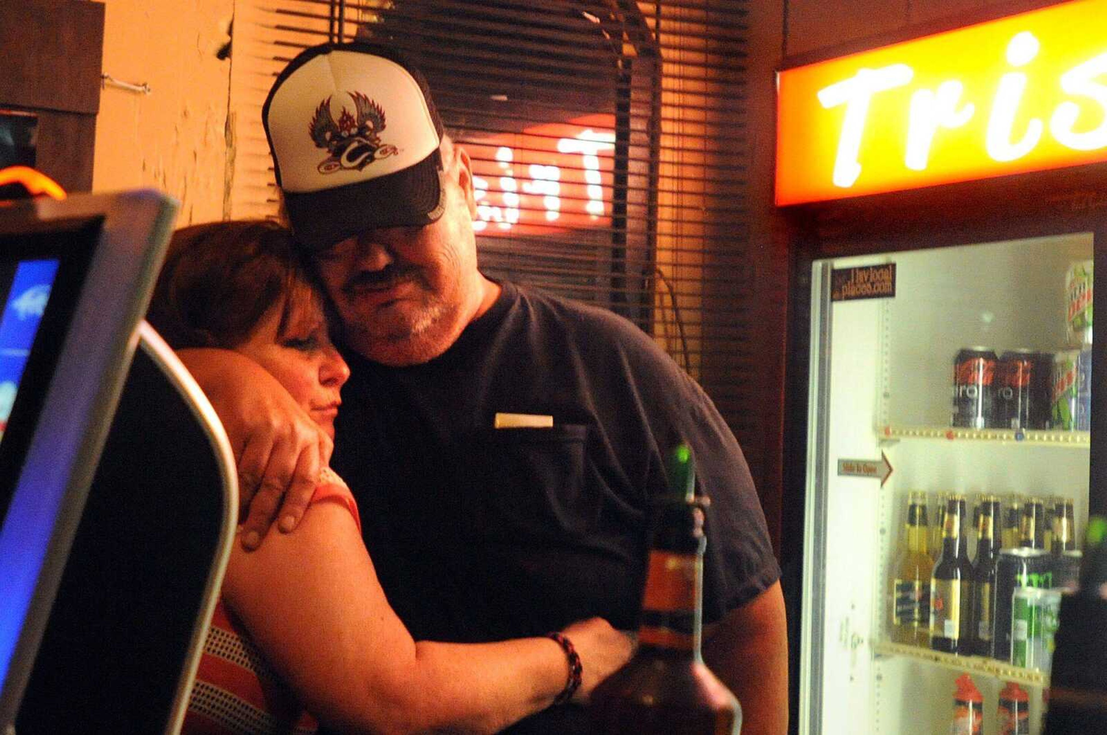 Hardy hugs regular and friend Steven Lutrell as he prepares to leave for the final time Saturday. (Laura Simon)