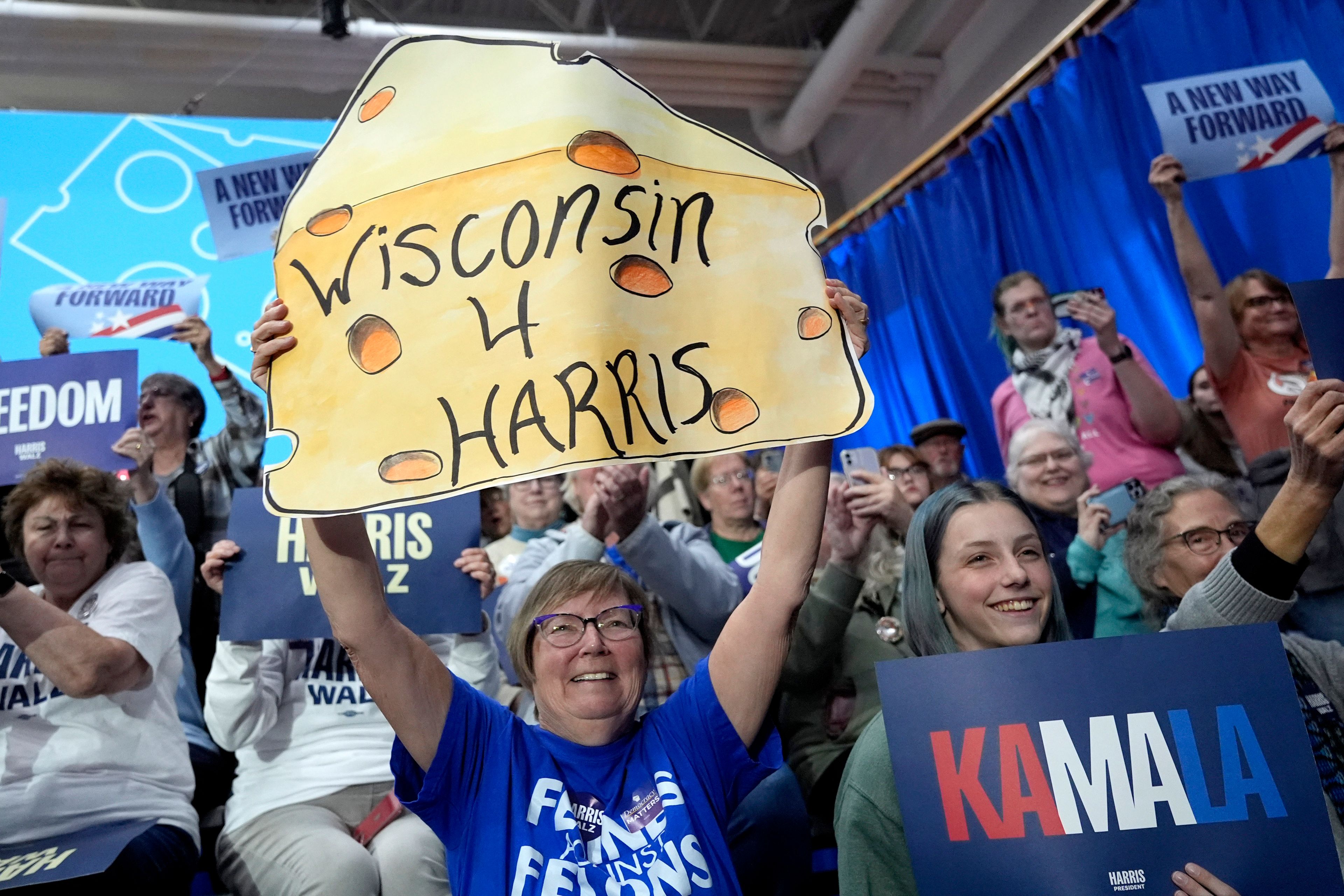 Attendees hold up asigns as Democratic presidential nominee Vice President Kamala Harris speaks during a campaign rally at the University of Wisconsin La Crosse, in La Crosse, Wis., Thursday, Oct. 17, 2024. (AP Photo/Jacquelyn Martin)