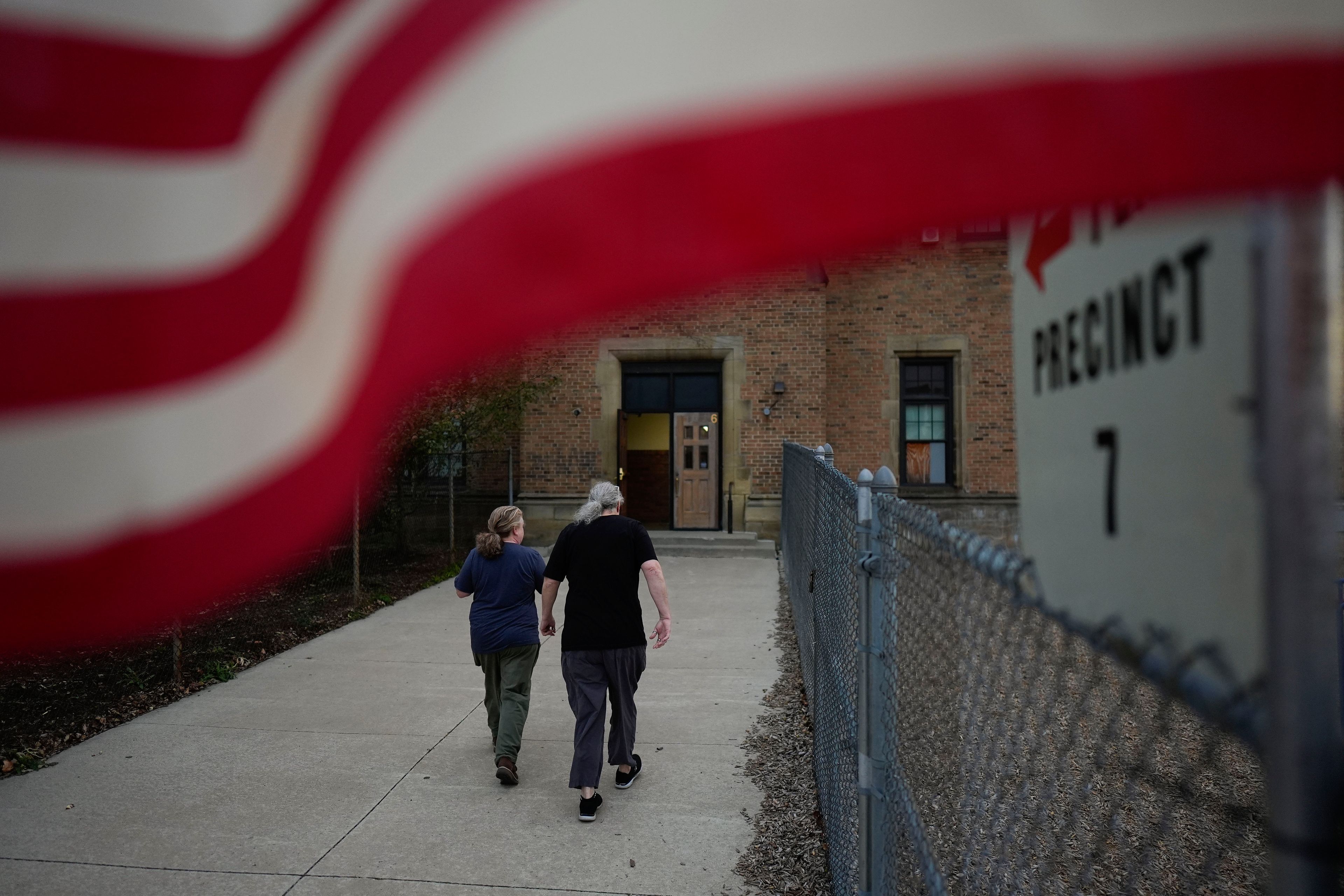 People arrive at a polling place, Tuesday, Nov. 5, 2024, in Dearborn, Mich. (AP Photo/Charlie Neibergall)