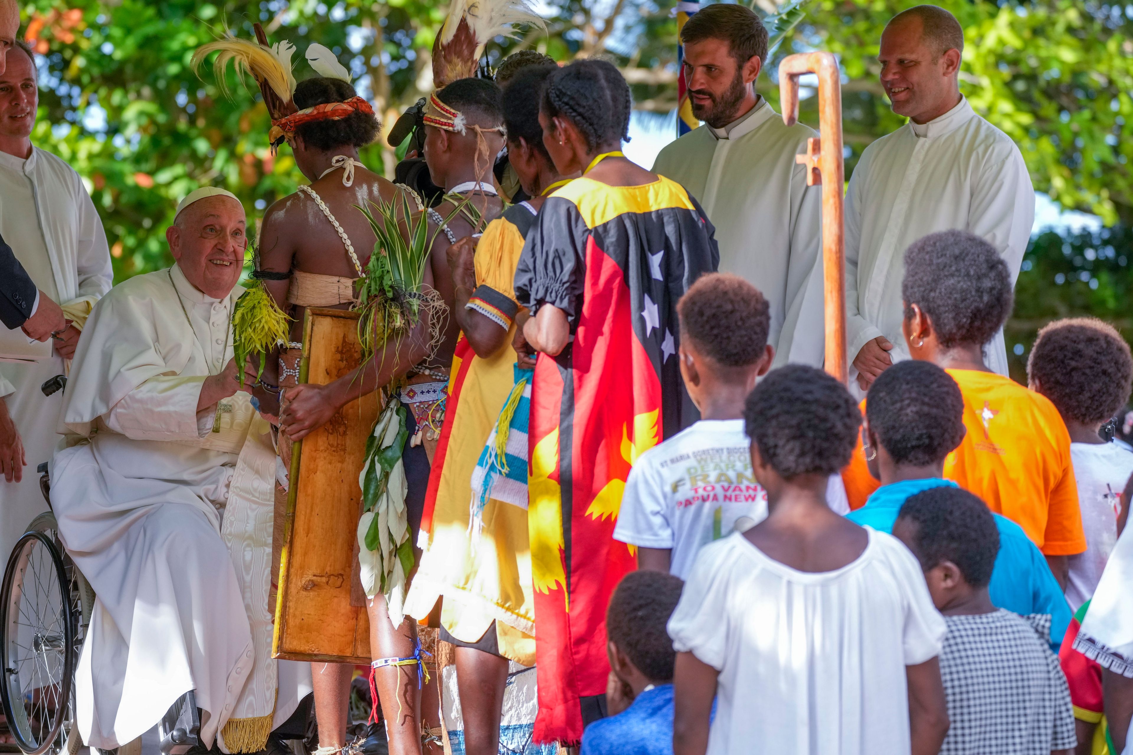 Pope Francis, left, meets with indigenous people at the Holy Trinity Humanistic School in Baro, near Vanimo, Papua New Guinea, Sunday, Sept. 8, 2024. Pope Francis celebrated the Catholic Church of the peripheries on Sunday as he traveled to the remote jungles of Papua New Guinea, bringing with him a ton of medicine and toys and a message of love overcoming violence for the people who live there.