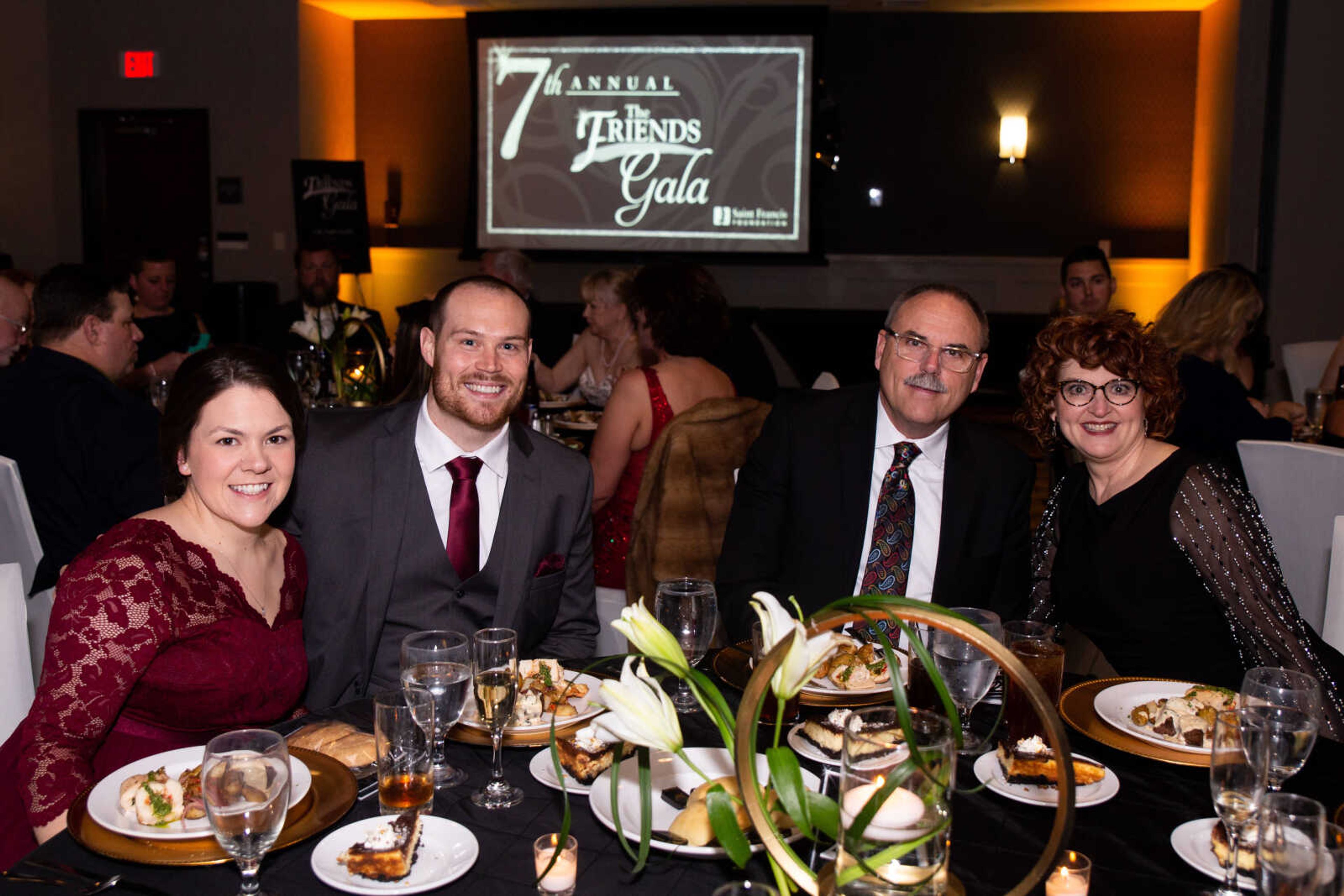 Erin and Ed Meixner, both APRN, FNP-BC, sit with David and Bobbi Palmer, APRN, MSN, FNP-BC, at the gala.