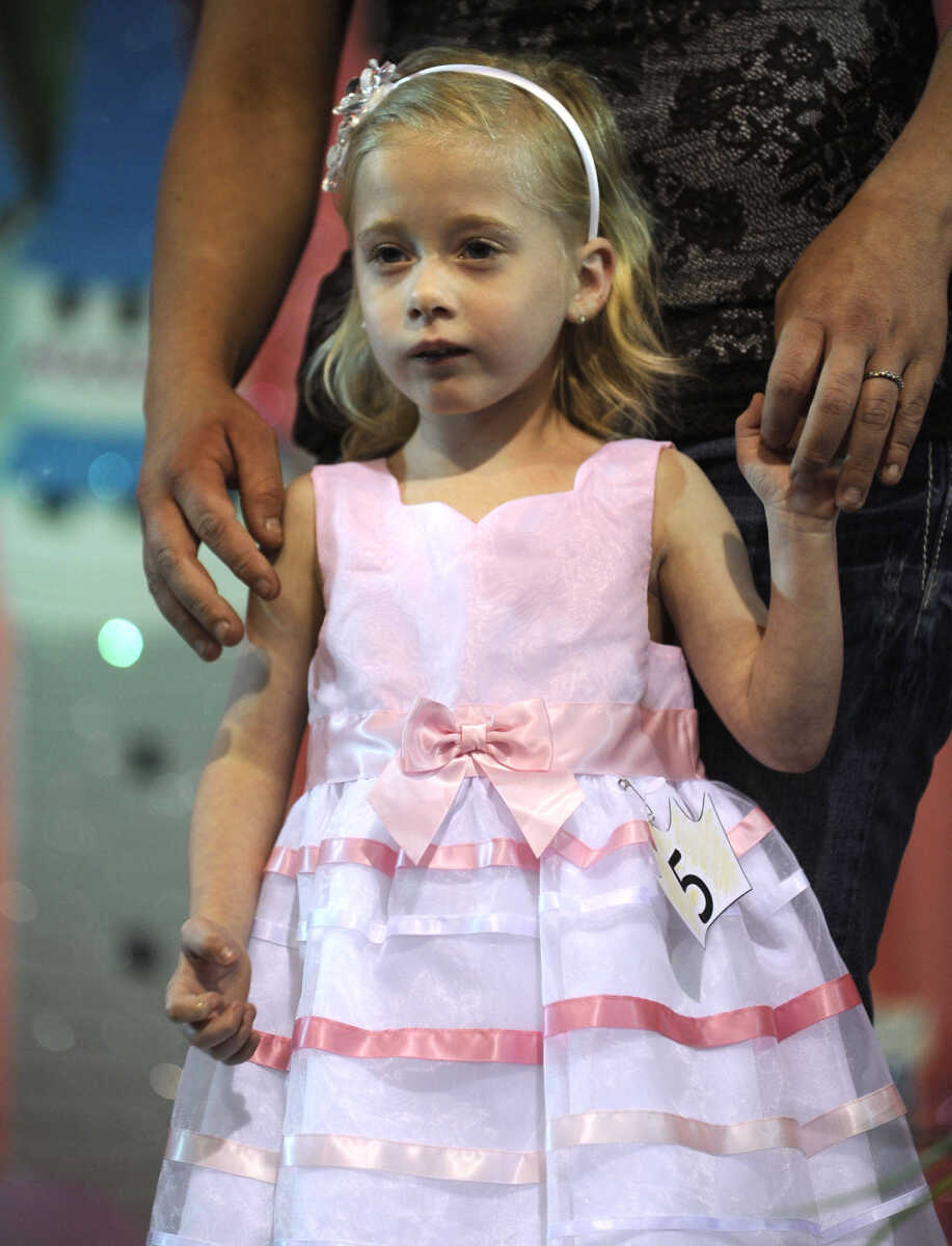 Kylie Stull poses for the judges in the 0-4 age division of the S. E. Missouri Angels Pageant on Saturday, April 26, 2014 at Scott City High School.