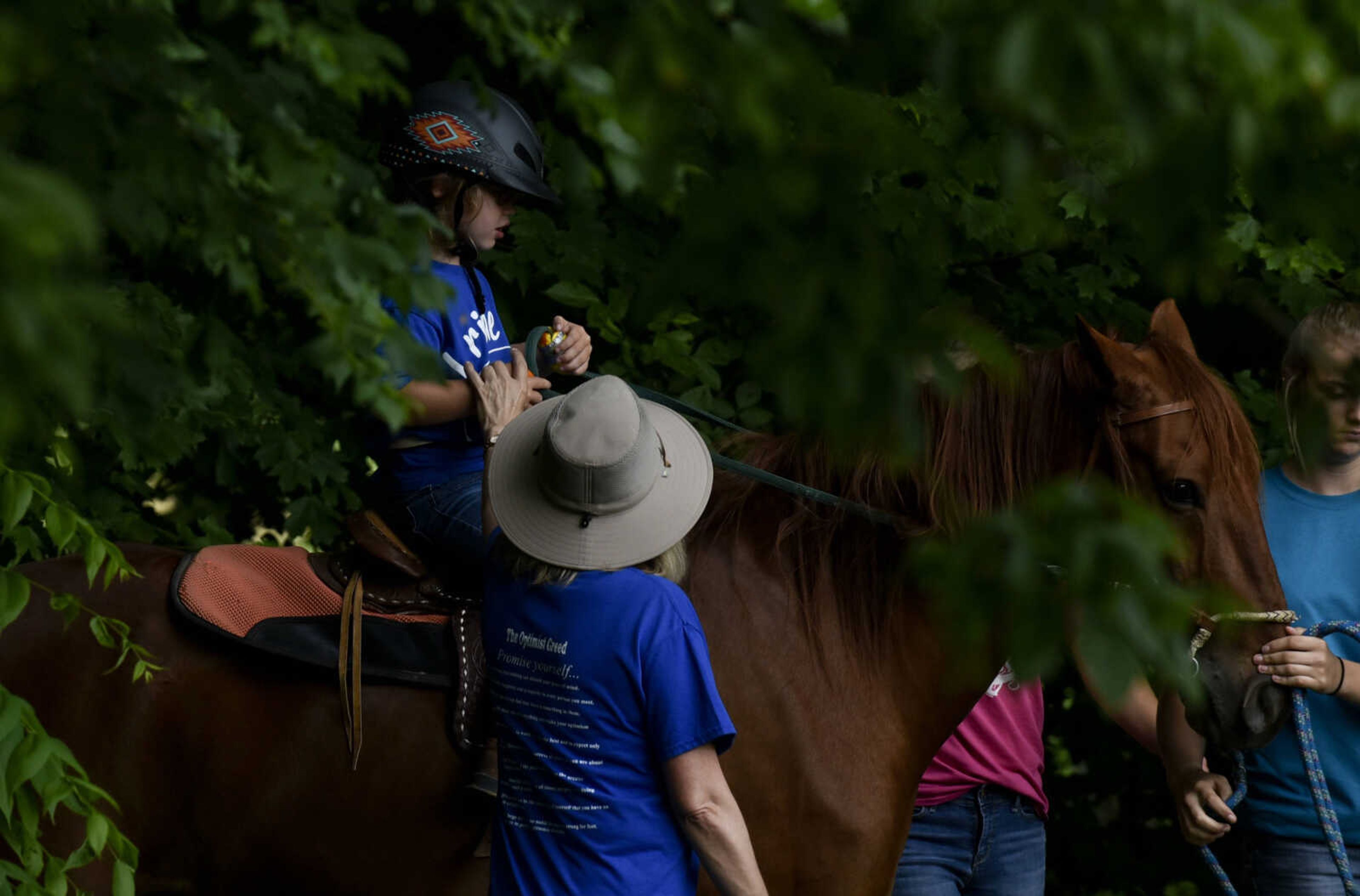 Lindyn Davenport rides Ranger, 15, as Paula Givens, side-walks alongside during a summer camp session at Mississippi Valley Therapeutic Horsemanship Friday, June 8, 2018 in Oak Ridge.