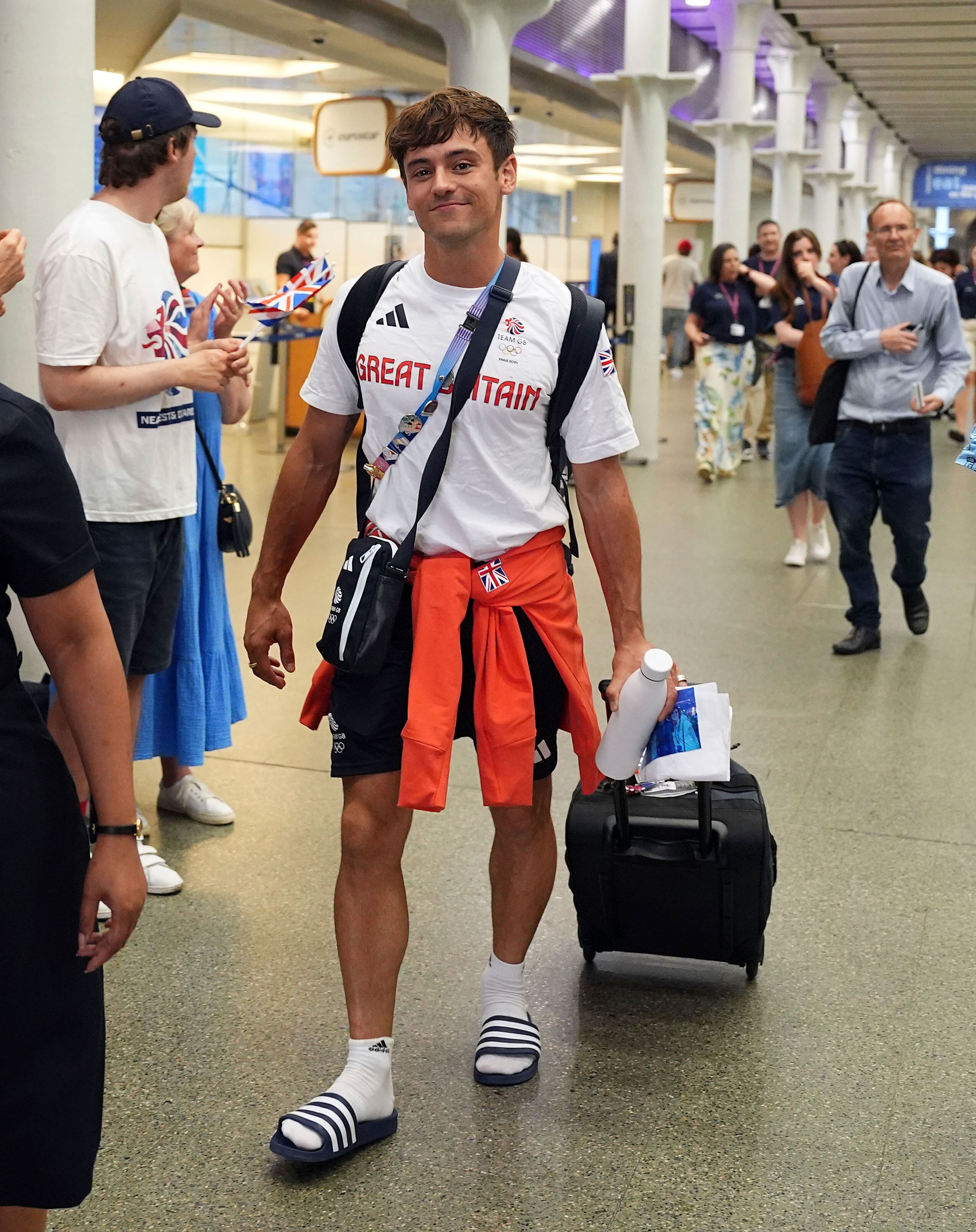 Great Britain's Tom Daley arrives by Eurostar into London St. Pancras International train station after competing at the 2024 Paris Olympic Games in France, Monday Aug. 12, 2024. Five-time Olympic gold medalist Tom Daley has announced his retirement from diving. (Jordan Pettitt/PA via AP)