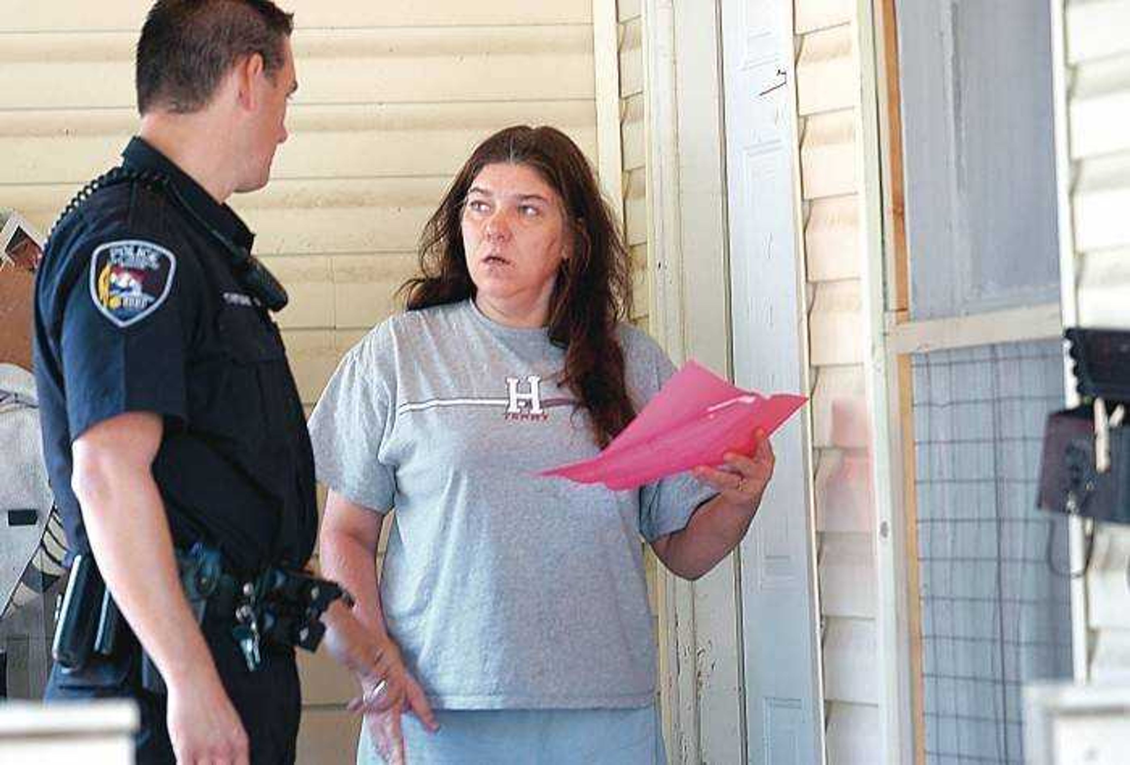 Laura Nutting of Cape Girardeau was surprised to hear that her pink yard sale sign posted on a telephone pole off William Street violated city ordinance. Patrolman and nuisance abatement supervisor Ty Metzger took down Nutting's yard sale sign and brought it to her house to make her aware of the new sign ordinance.