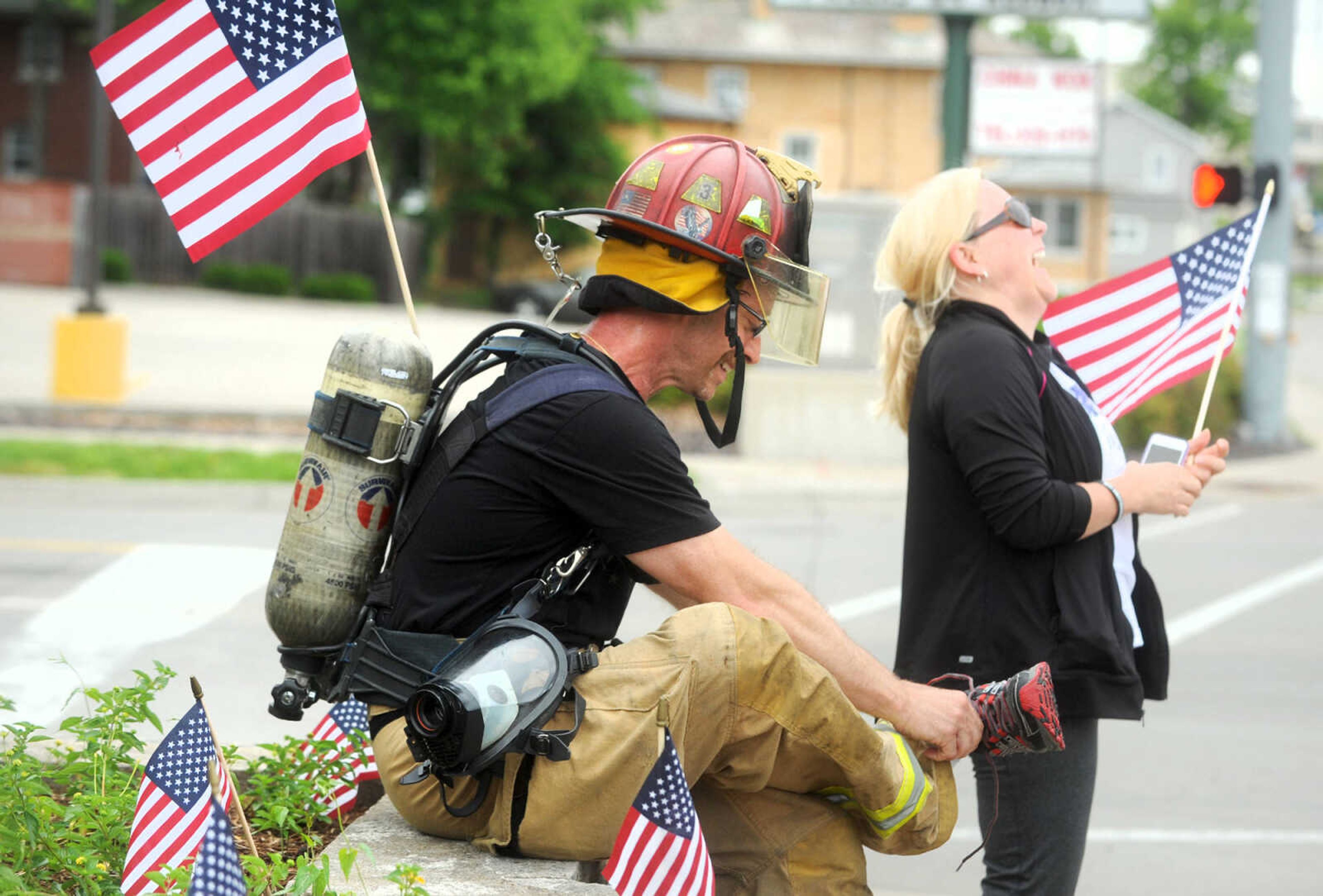 LAURA SIMON ~ lsimon@semissourian.com

Patti August laughs as her husband Trent changes his shoes during the first ever Carry the Load event, Monday, May 25, 2015, in Cape Girardeau.