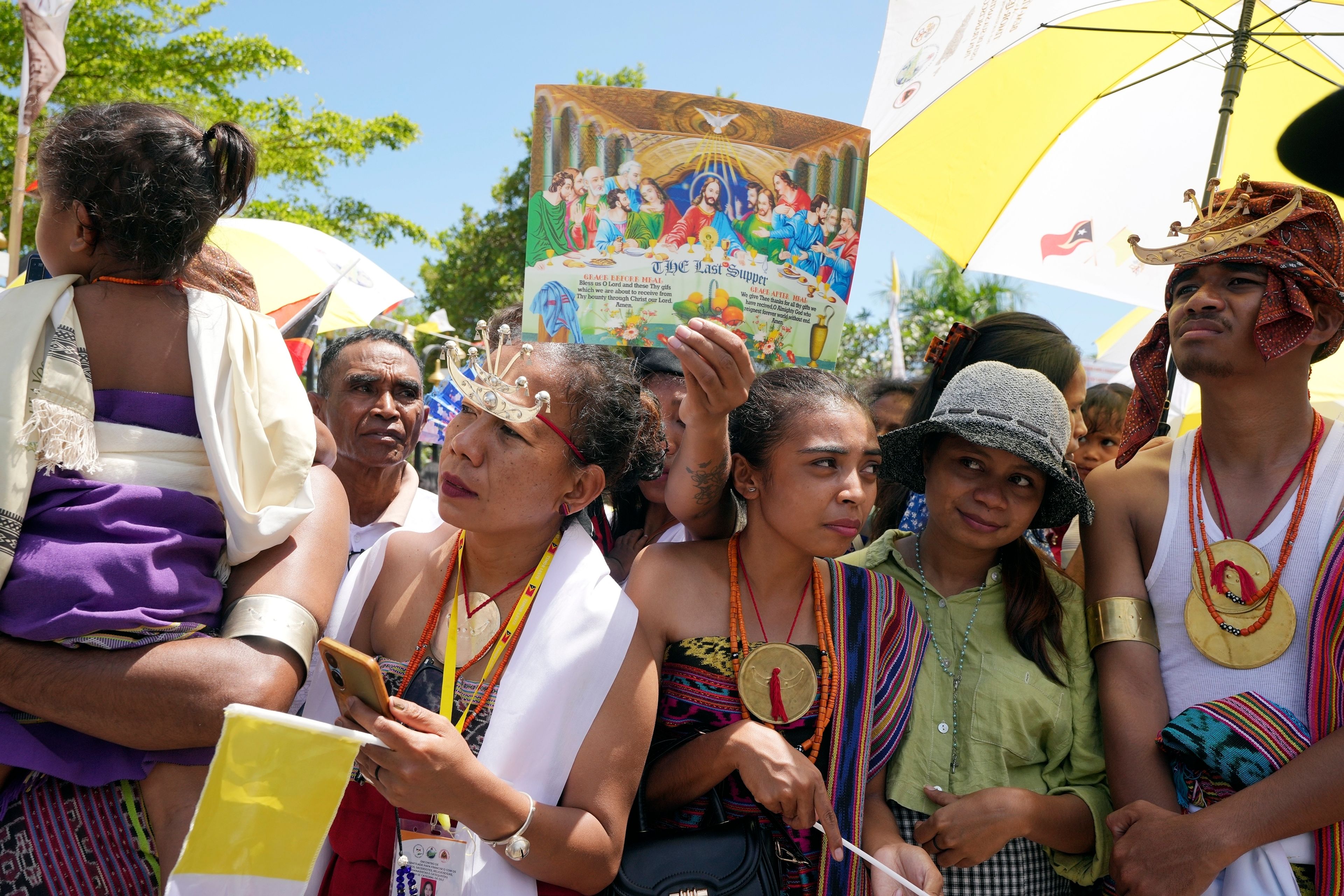 People wait for Pope Francis near the Cathedral of the Immaculate Conception in Dili, East Timor, Tuesday, Sept. 10, 2024. (AP Photo/Firdia Lisnawati)