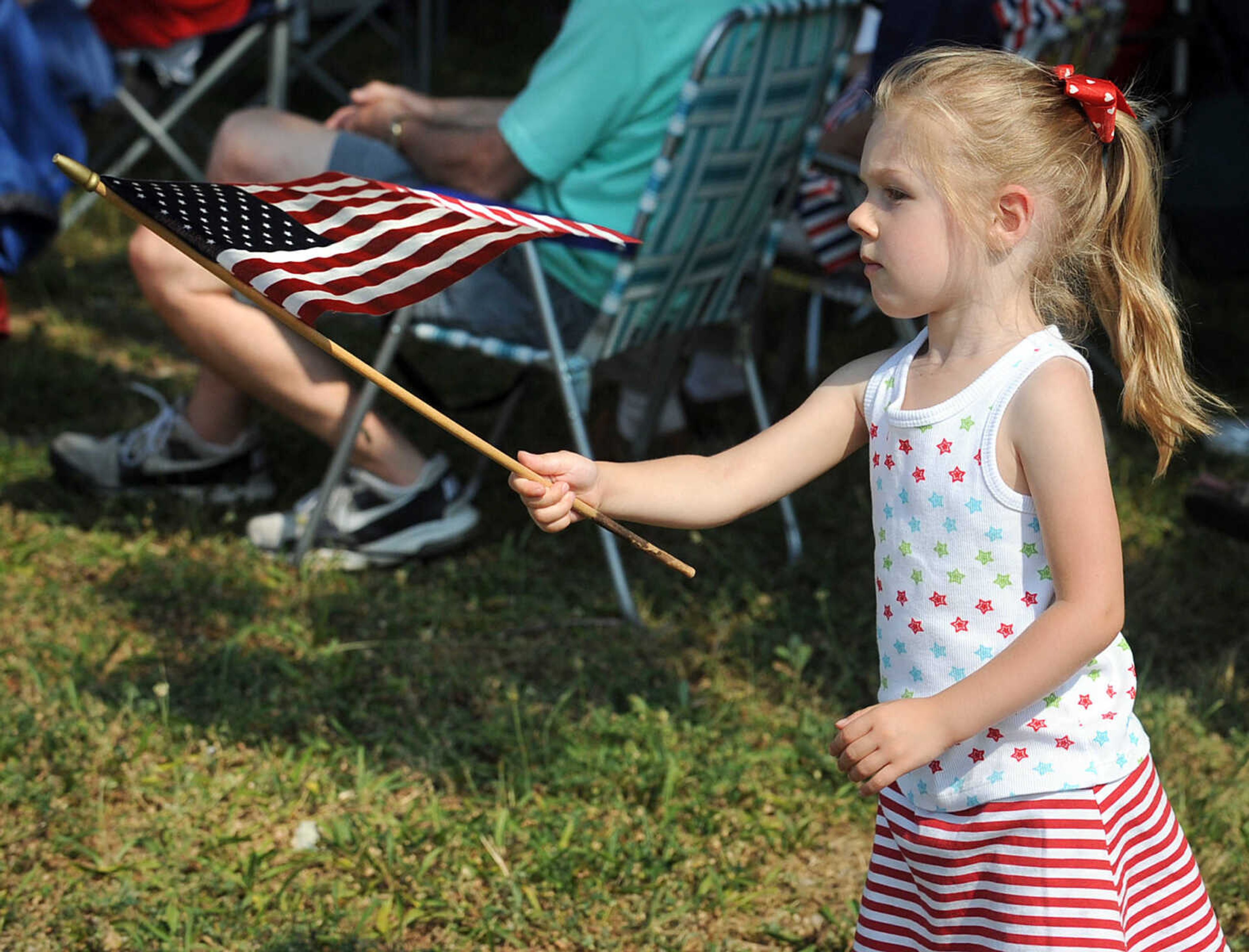 LAURA SIMON ~ lsimon@semissourian.com
Bella Buffington waives an American flag Monday morning, May 28, 2012 at the Memorial Day service at Jackson City Cemetery.