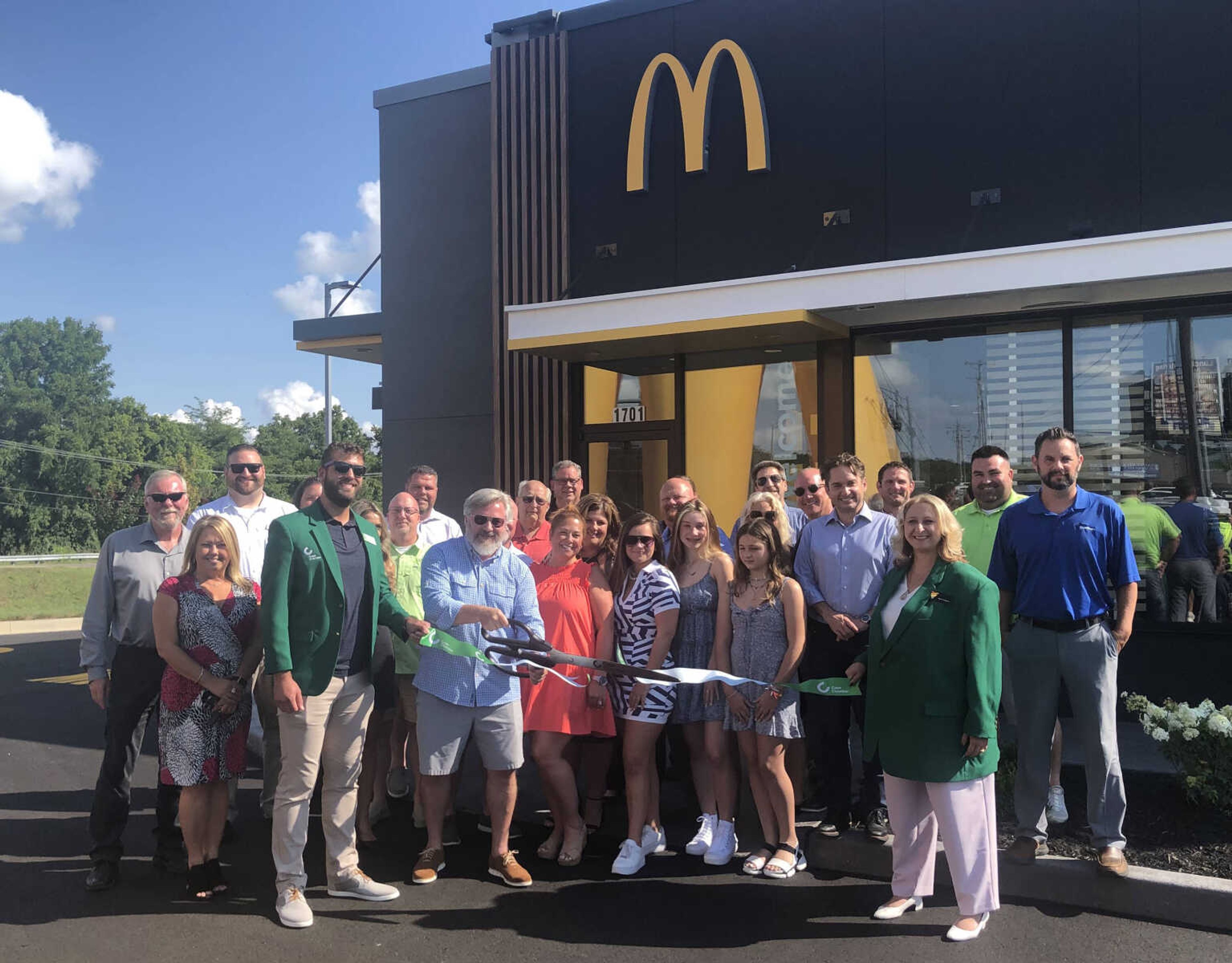 Shannon Davis, franchise owner of the McDonald's restaurant at 1701 N. Kingshighway in Cape Girardeau, handles the giant scissors during Tuesday's ribbon cutting event.