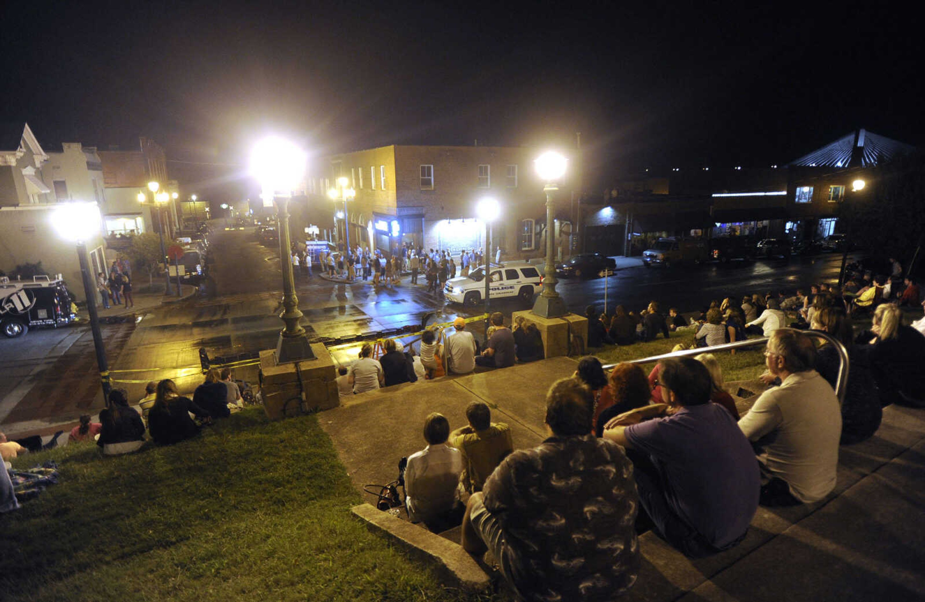 FRED LYNCH ~ flynch@semissourian.com
Spectators watch as the scene around The Bar is prepared for "Gone Girl" filming Friday, Sept. 27, 2013 in downtown Cape Girardeau.