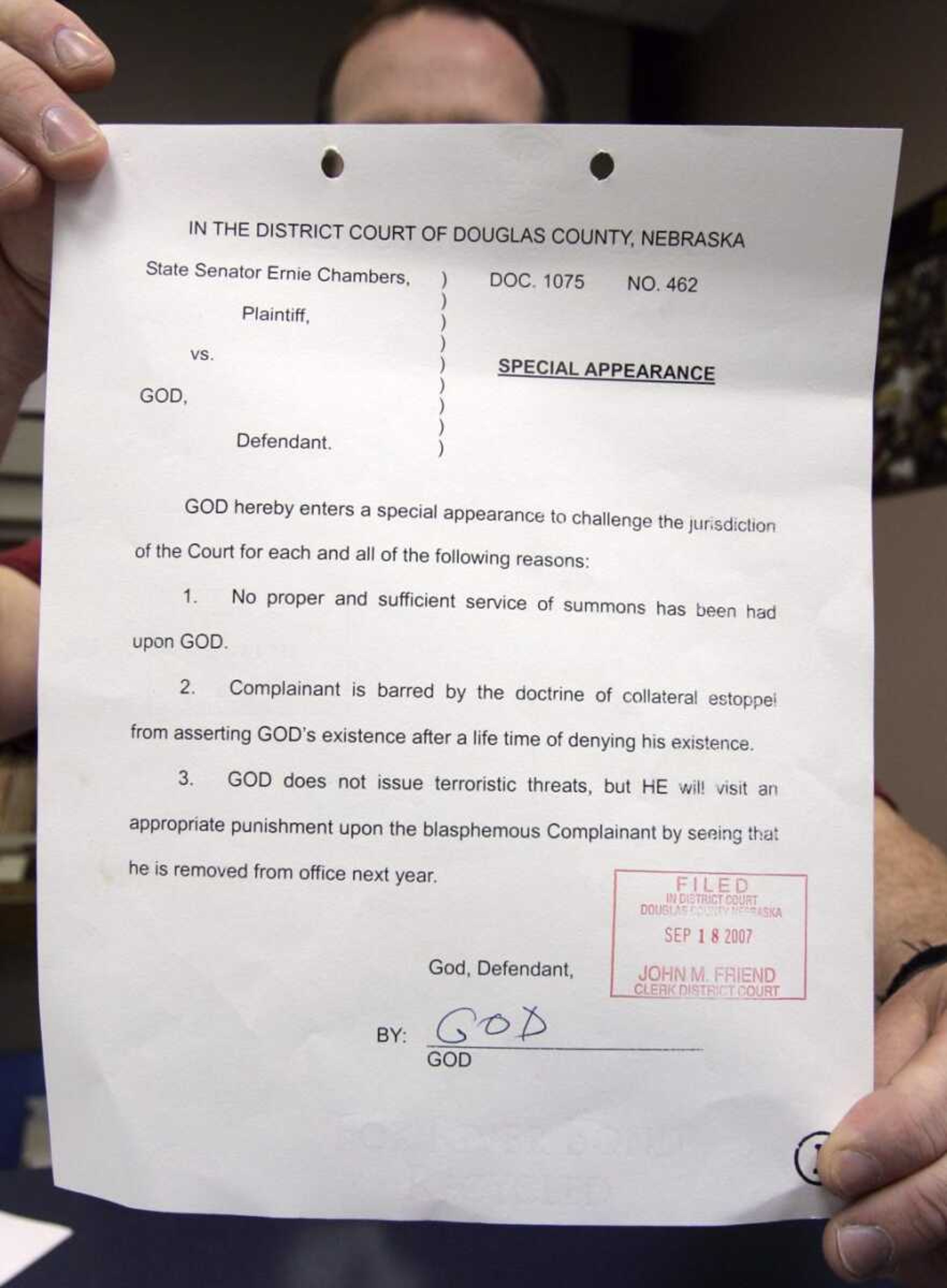 Douglas County District Court legal file clerk Mark McGuire held legal papers Friday pertaining to a lawsuit filed by Nebraska state Sen. Ernie Chambers of Omaha against God  in Omaha. God apparently responded to a lawsuit filed by Chambers, and one of the filings seems to have dropped in from the heavens. Signed by "God," it argues the defendant is immune from some earthly laws and the court lacks jurisdiction over God. St. Michael the Archangel is listed as a witness. (NATI HARNIK ~ Associated Press)