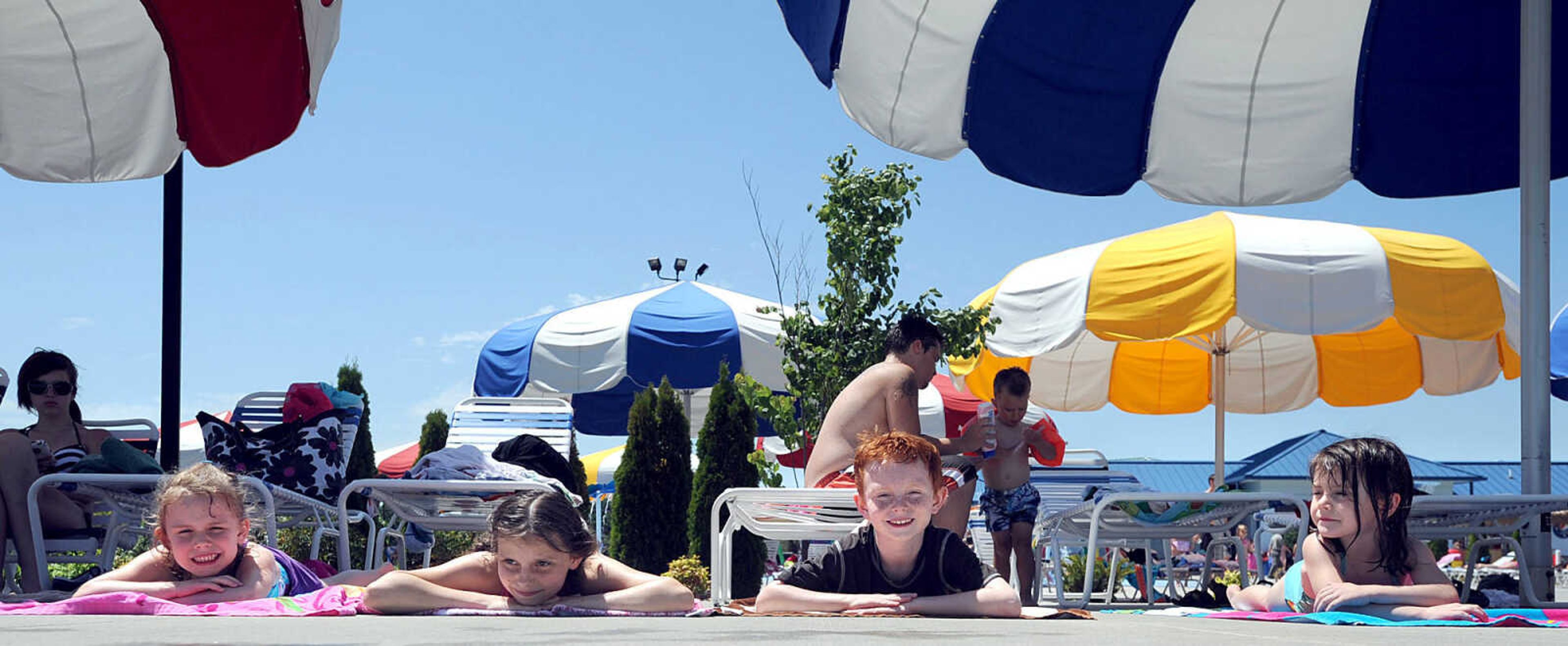 LAURA SIMON ~ lsimon@semissourian.com
From left, Mary Kate MacKinnon, Alison Ambul, Eamonn MacKinnon and Anna Opal MacKinnon stretch out on towels Tuesday, May 29, 2012 at Cape Splash in Cape Girardeau.