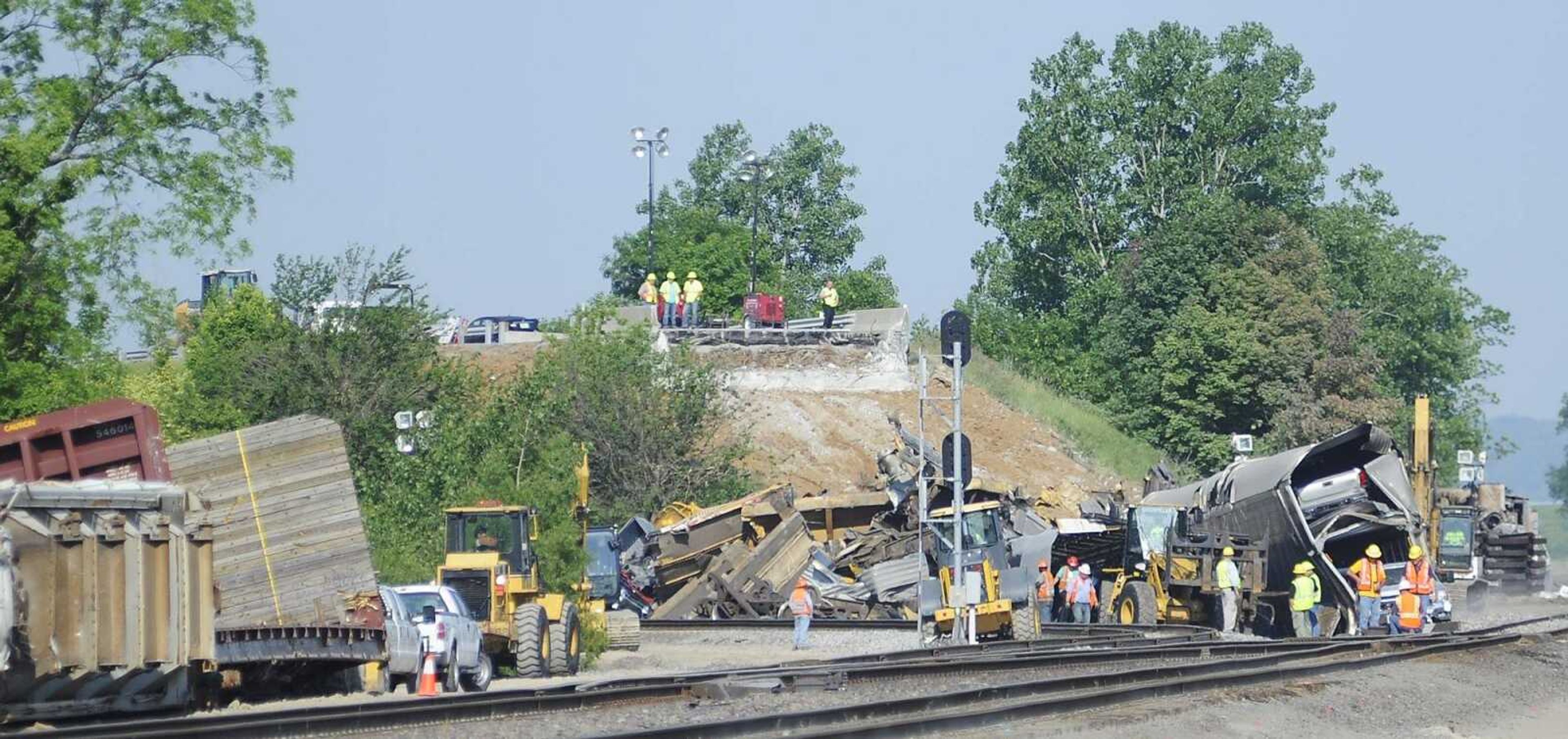 Cleanup continues Monday, May 27, at the site of a train collision that destroyed a highway over pass in Scott County. An overpass on Route M near Rockview, Mo., collapsed after about two dozen rail cars that smashed into the bridge's support pillars when a Burlington Northern Santa Fe train and a Union Pacific train collided about 2:20 a.m. Saturday, May 25. (Adam Vogler)