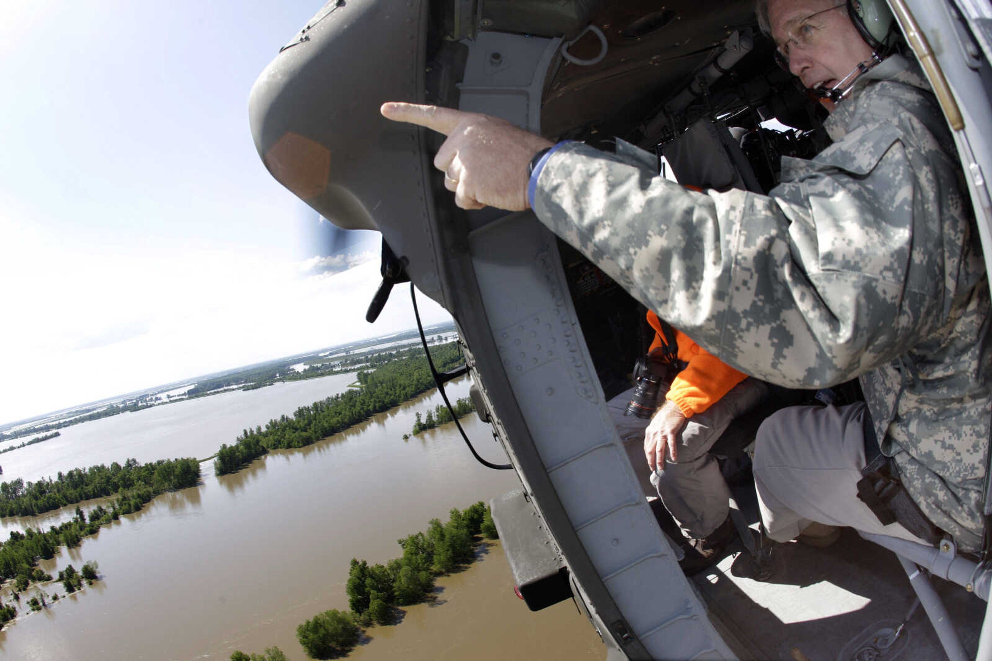 Missouri Gov. Jay Nixon points at floodwaters as he flies near the Birds Point levee in a Missouri National Guard helicopter Tuesday, May 3, 2011, over Mississippi County, Mo. After the levee was intentionally breached by the Army Corps of Engineers on Monday night Nixon said state leaders would do everything "within our power to make sure the levee is rebuilt and those fields, the most fertile fields in the heartland, are put back in production." (AP Photo/Jeff Roberson)