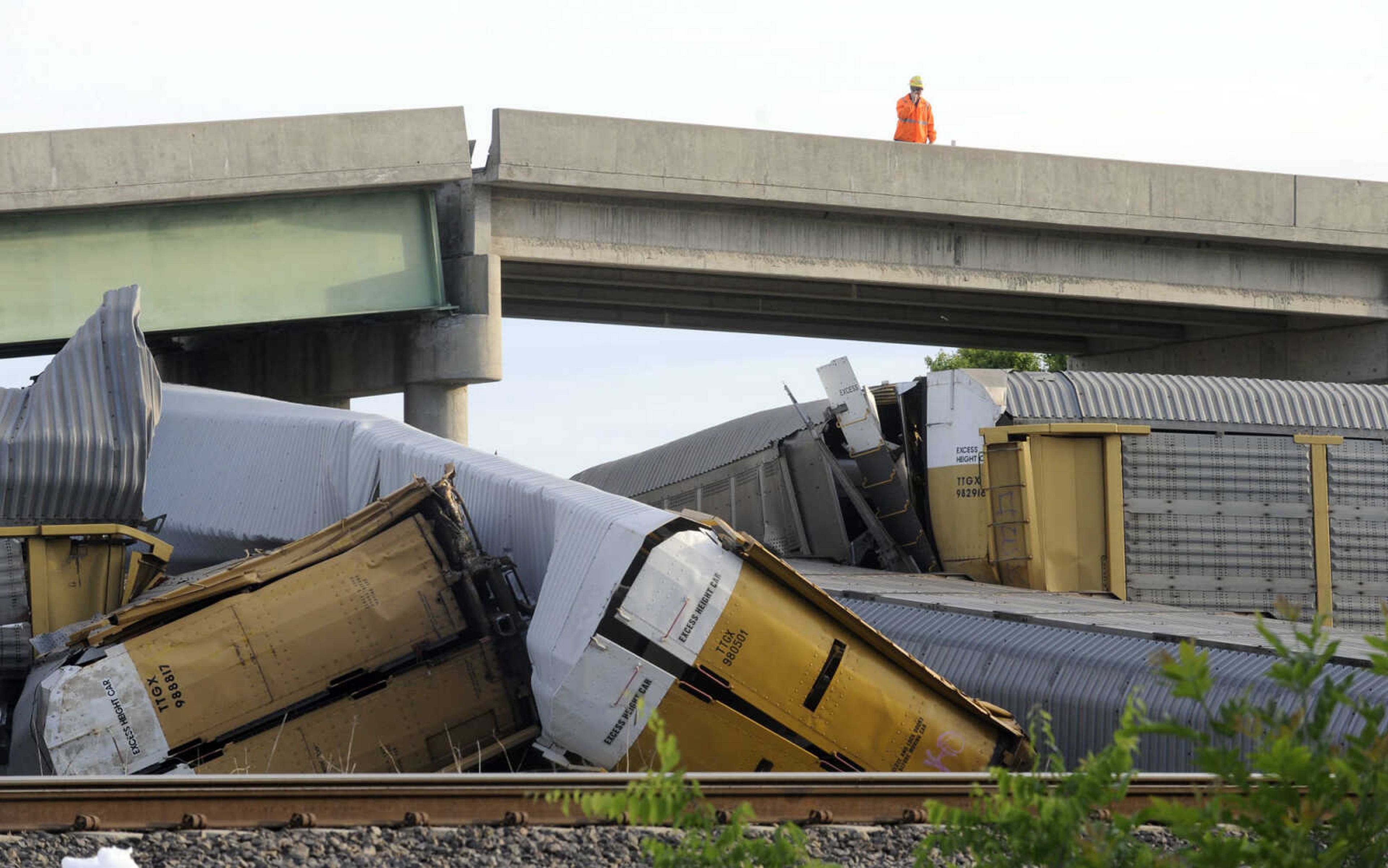 Several train cars were derailed when a Union Pacific train and Burlington Northern Santa Fe collided near Rockview, Mo. Saturday, May 25, 2013. The cars were pushed in to the supports of the Route M overpass causing it to collapse. (Fred Lynch)