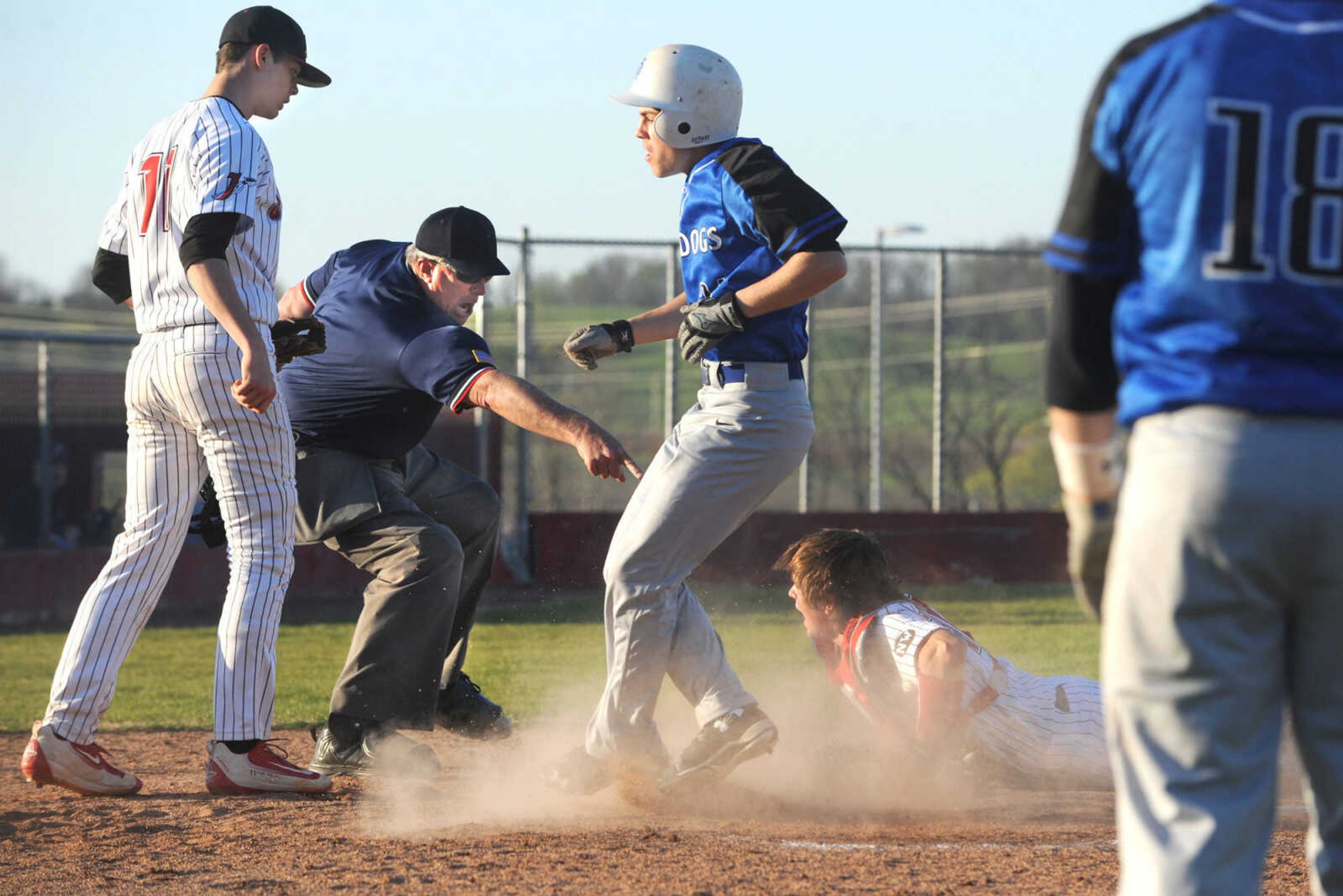 FRED LYNCH ~ flynch@semissourian.com
The umpire rules Notre Dame's Noah Arnzen is safe at home before Jackson catcher Braeden Dobbs tagged him, as relief pitcher Colton Weber looks on, during the ninth inning Monday, April 4, 2016 in Jackson. It was the third run for Notre Dame which held for their 3-2 win over Jackson.