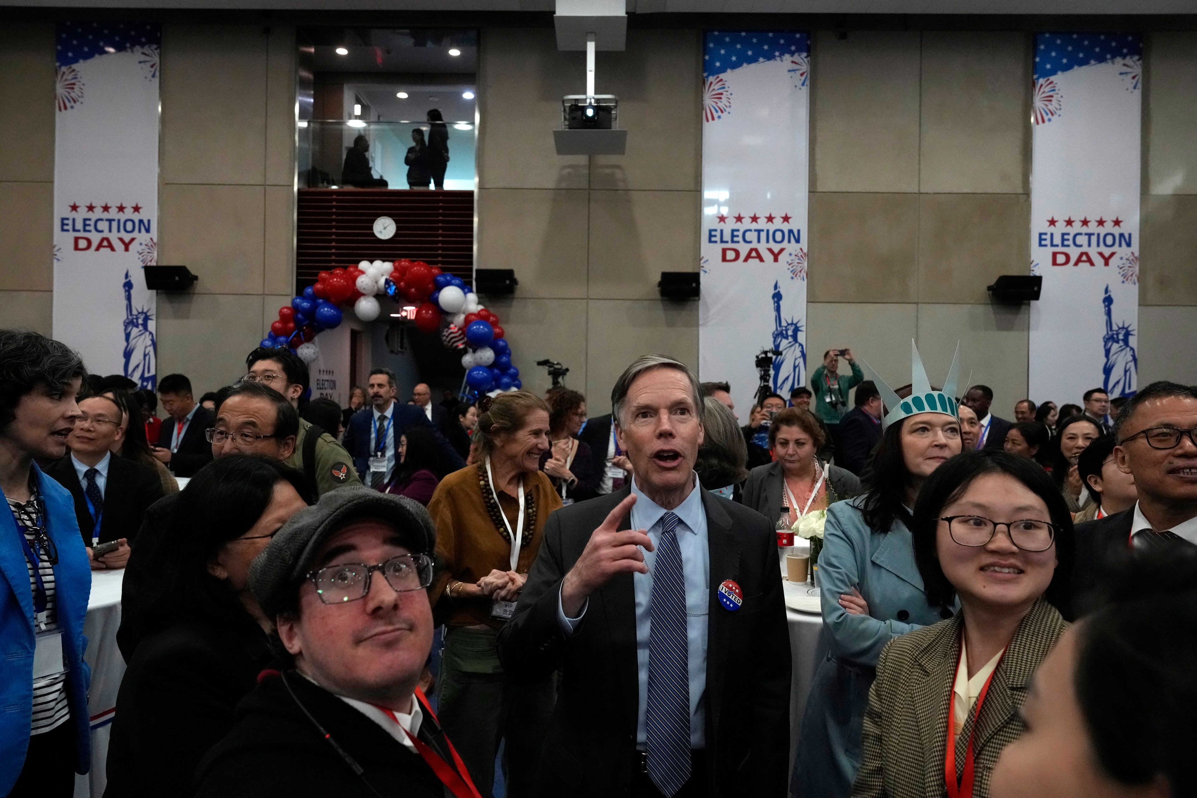 U.S. Ambassador to China Nicholas Burns watches with other attendees as voting results are displayed on screen at a reception for the U.S. presidential election held at the U.S. Embassy in Beijing, Wednesday, Nov. 6, 2024. (AP Photo/Ng Han Guan)