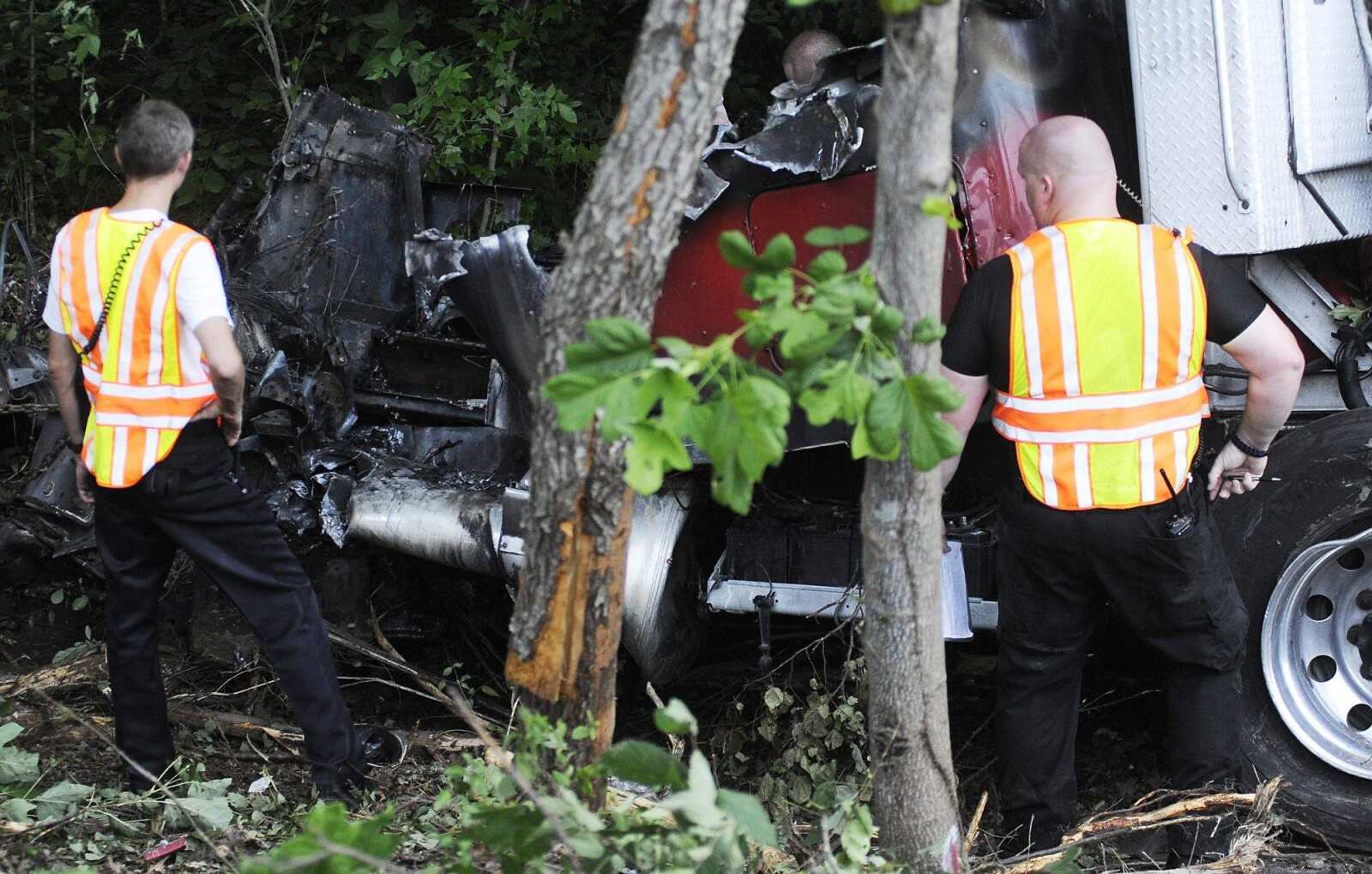 The remains of a semi-trailer involved in a single-vehicle accident on southbound Interstate 55 south of the mile marker 97.2 are pulled out of the woods Wednesday, July 17. One person was killed in the accident which occured just before 5 p.m. (Adam Vogler)