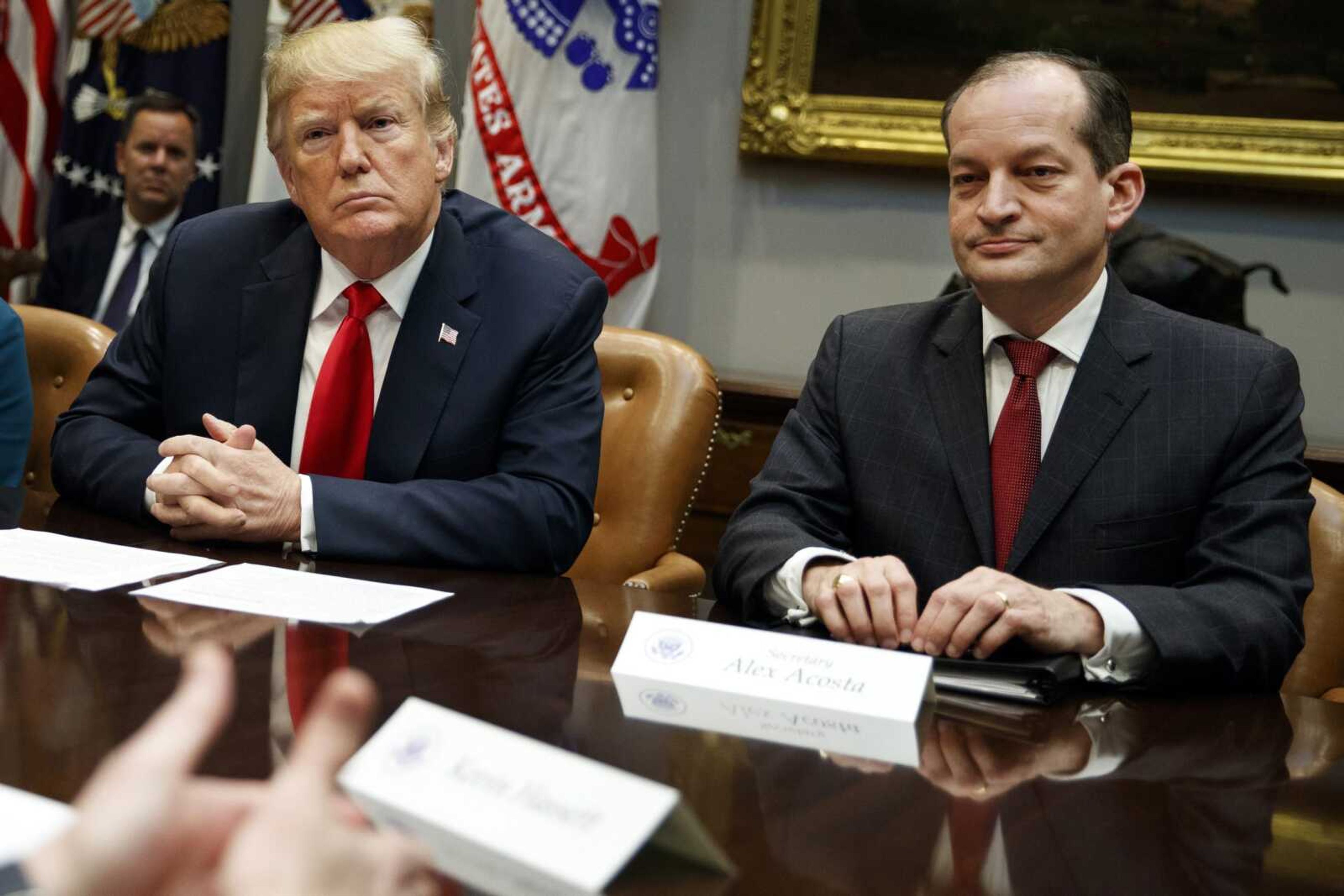 President Donald Trump, left, and Labor Secretary Alex Acosta listen during a September 2018 meeting of the President's National Council of the American Worker in the Roosevelt Room of the White House in Washington.