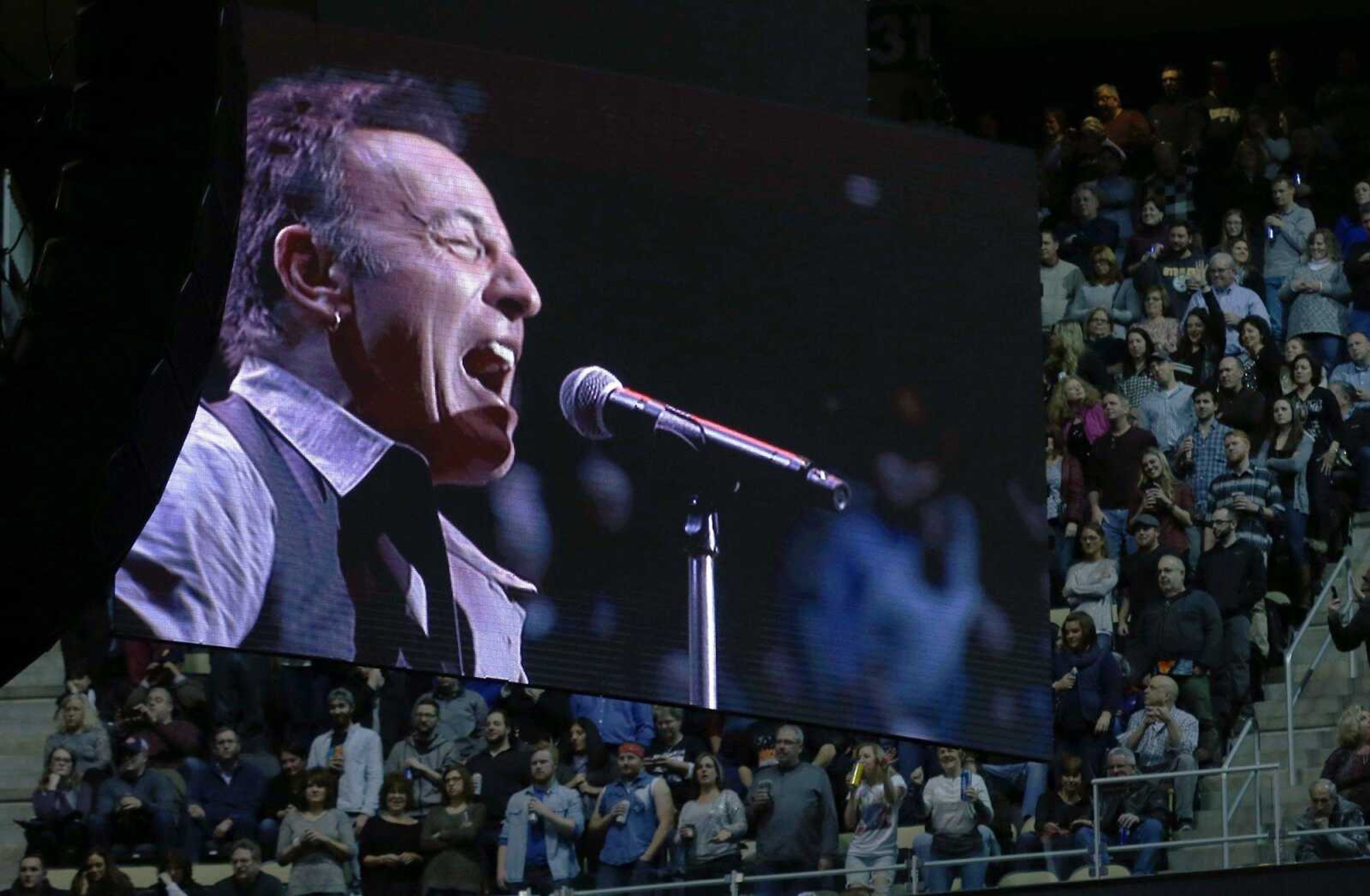 Bruce Springsteen is projected onto a screen in front of the crowd as he performs with the E Street Band in the first stop of his River Tour 16 concert Saturday in Pittsburgh.